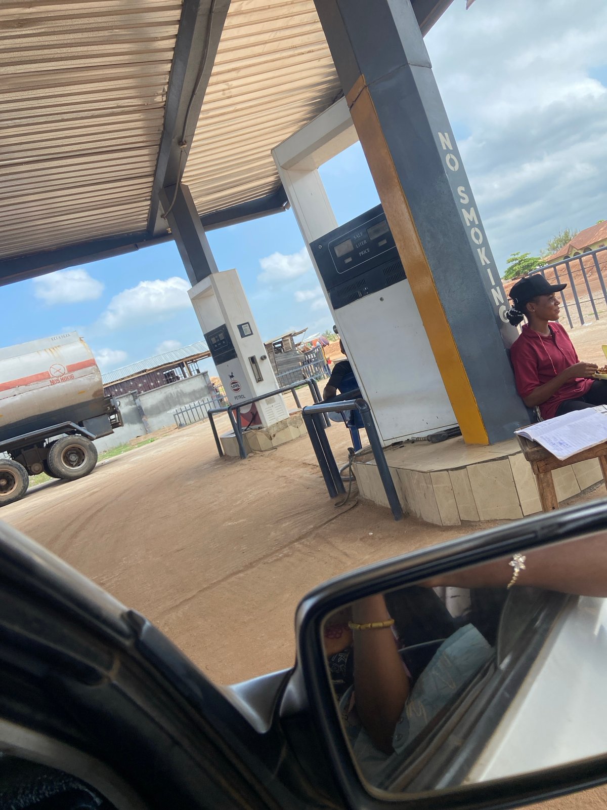 Woman seen atop gas pump in Zango-ndaji, Nigeria