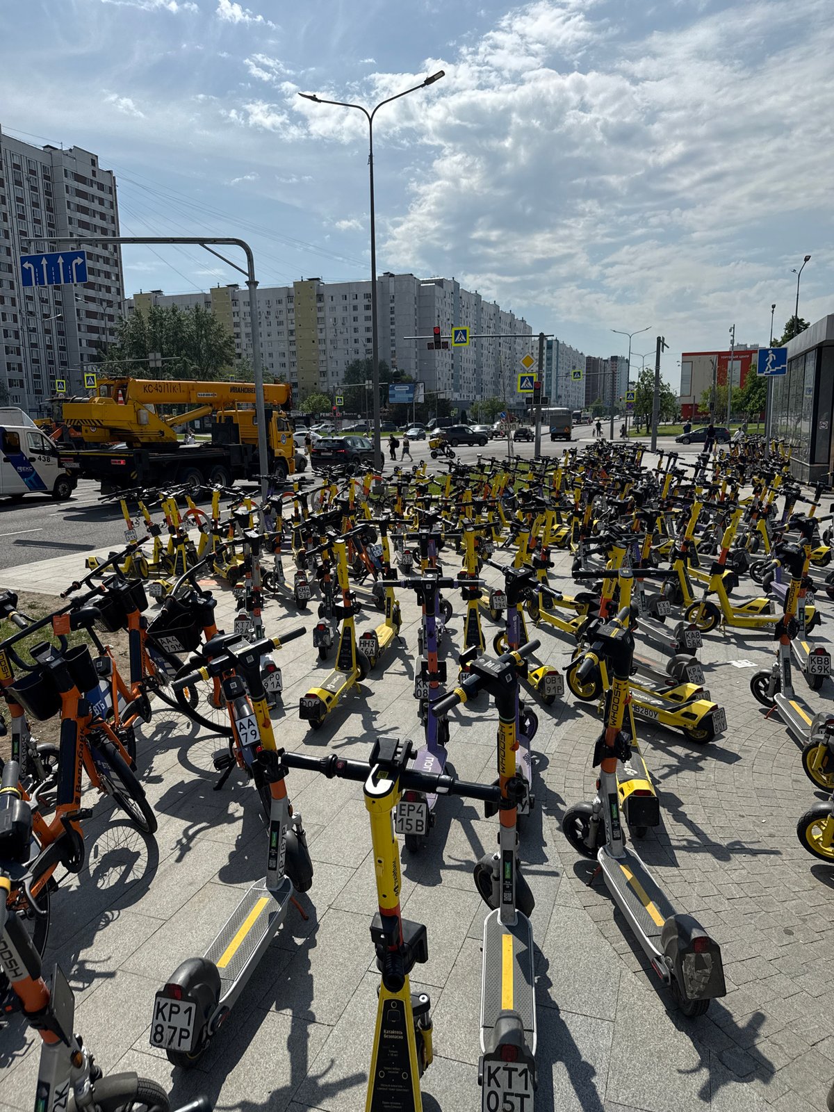 Rental scooters and bikes clustered in Moscow parking area