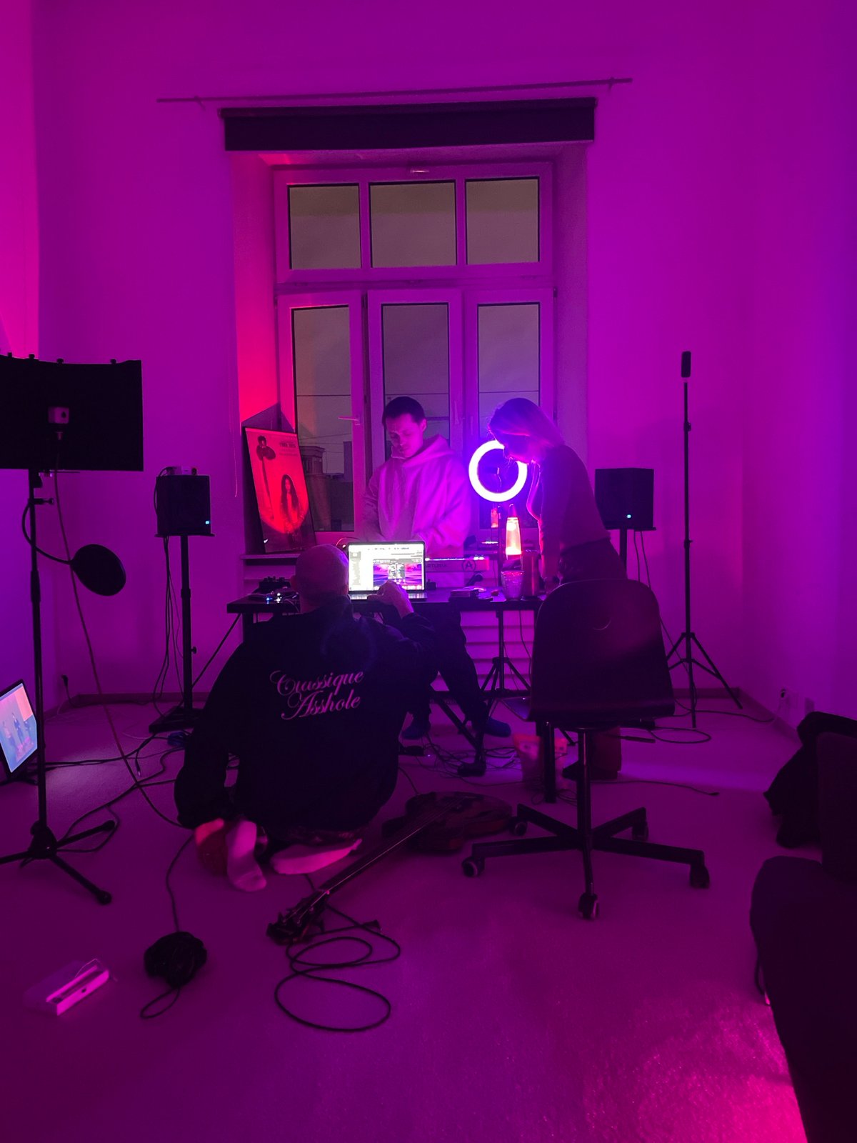 Two people gather in colorfully lit indoor space