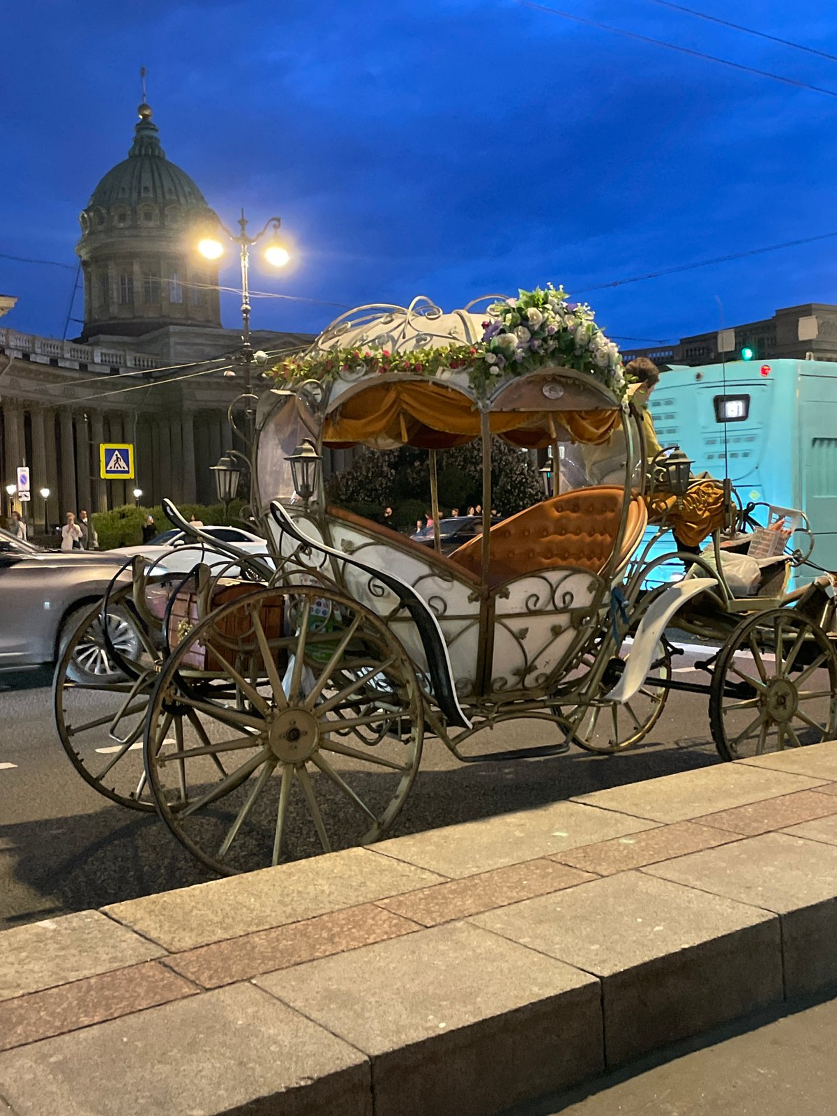 Ornate flower-decorated carriage spotted parked at dusk