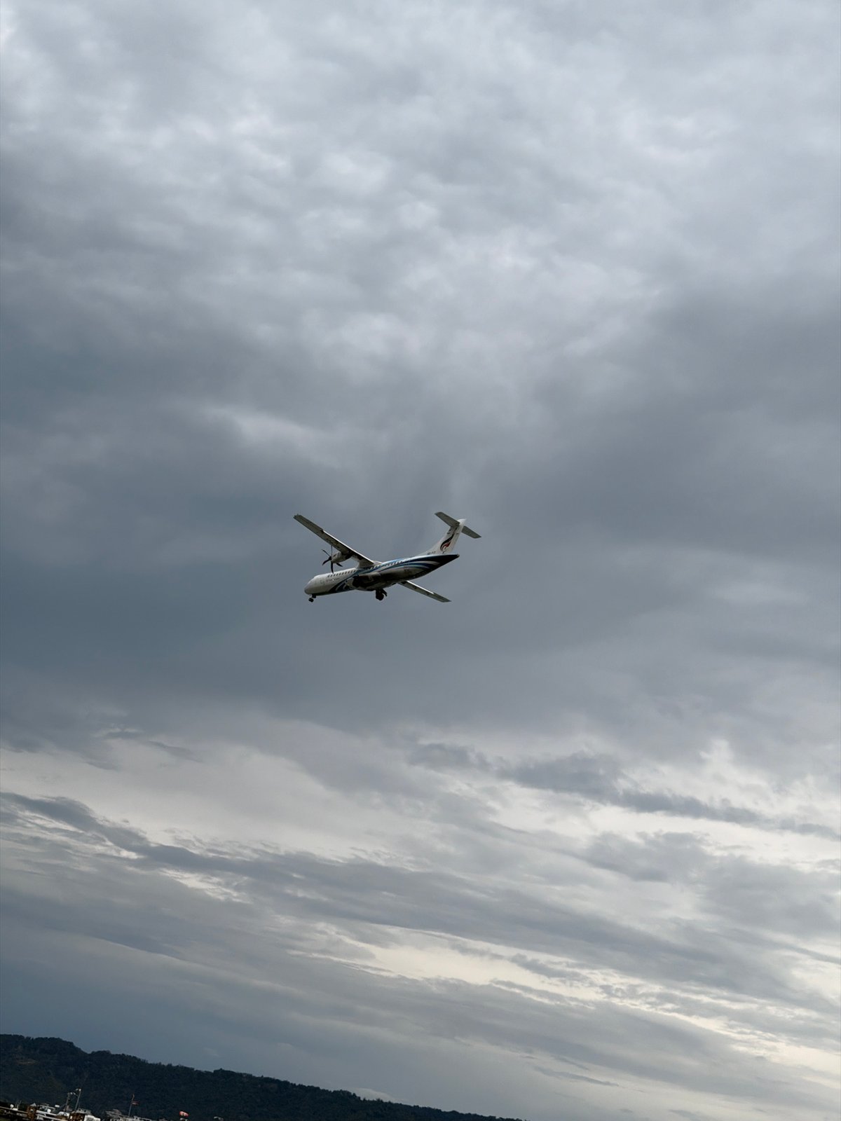 Longtail boats, oyster-crusted rocks, and a turboprop over Ko Samui