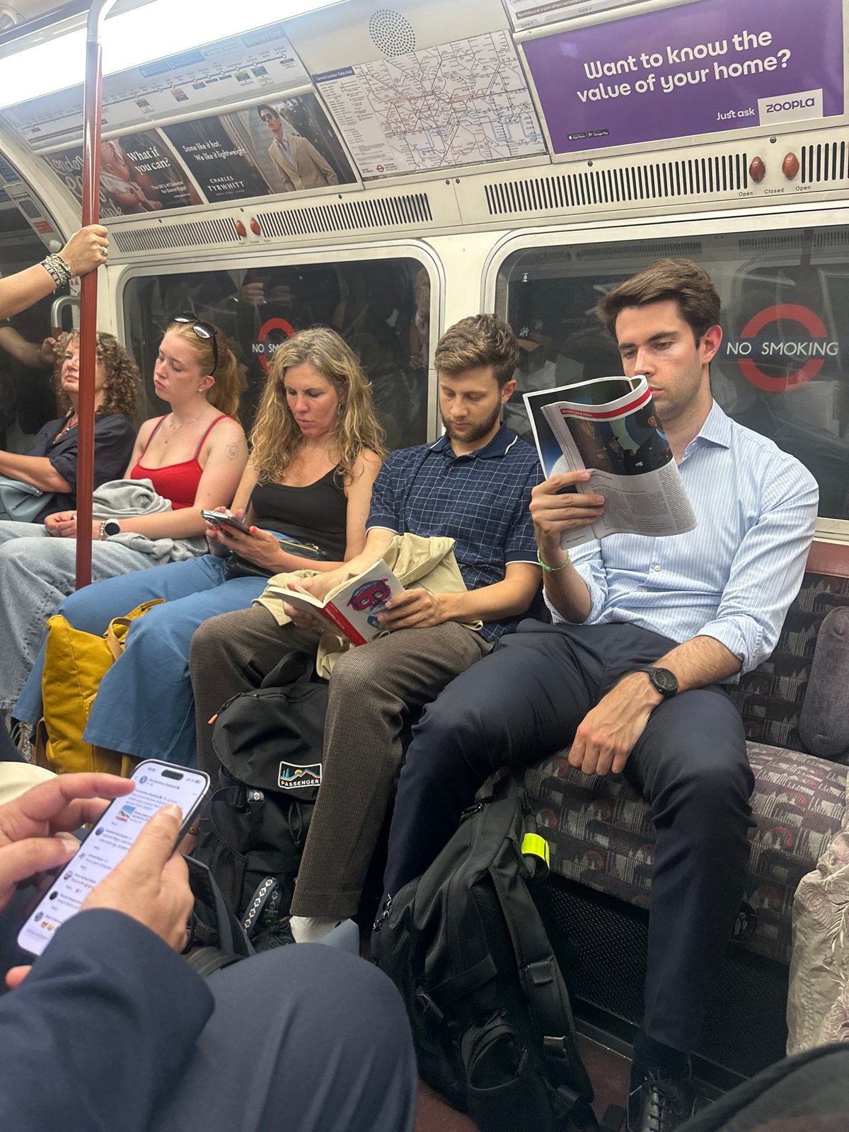 Passengers riding the London Underground on a quiet evening commute