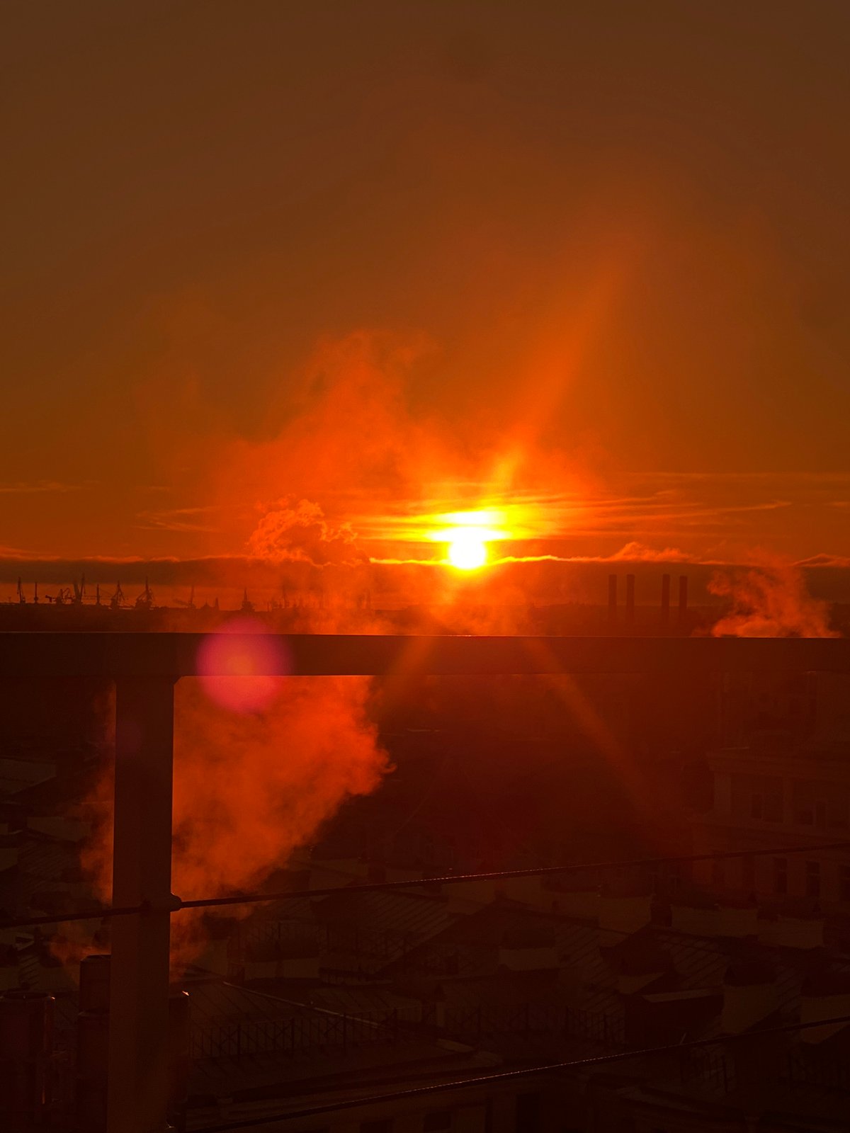 Couple enjoys sunset view from Saint Petersburg balcony