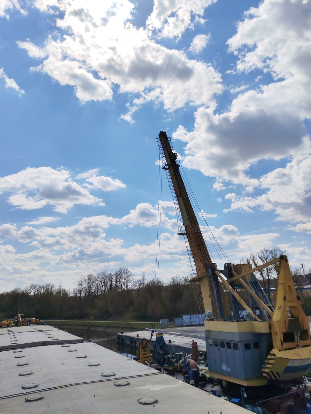 Industrial barge with cranes navigates Moscow Canal near Yakhroma