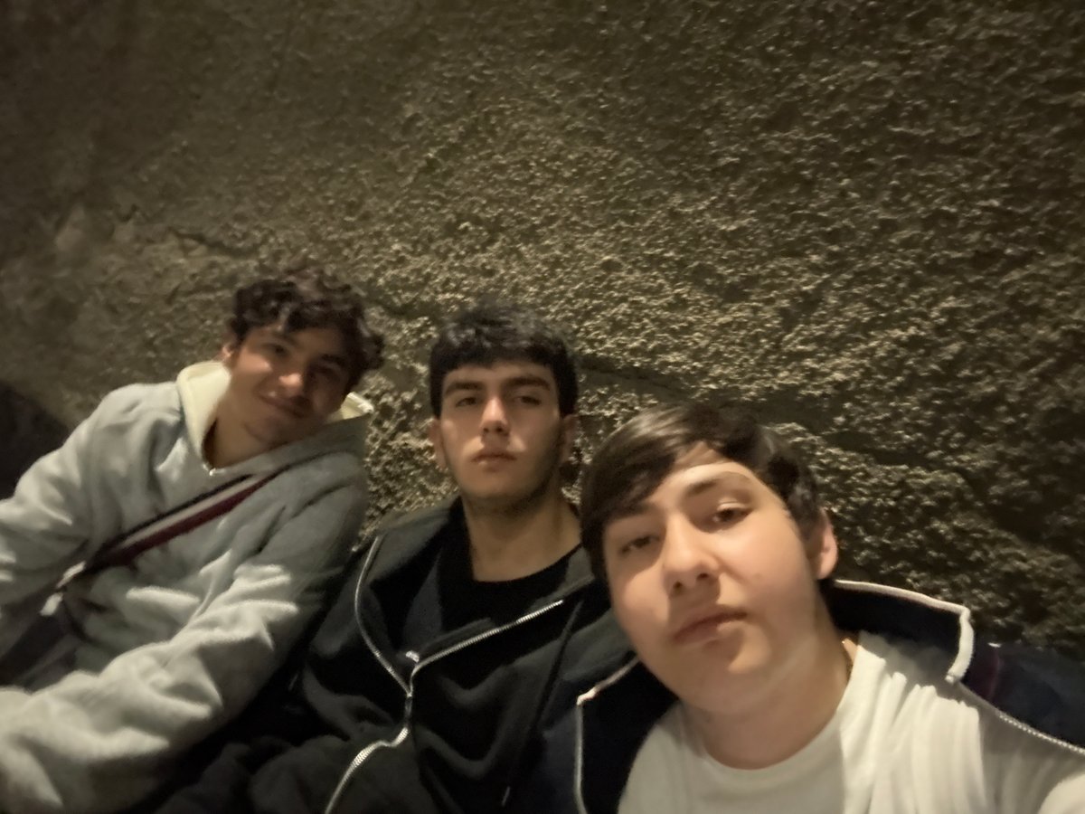 Young men take selfie in nighttime Yerevan street scene