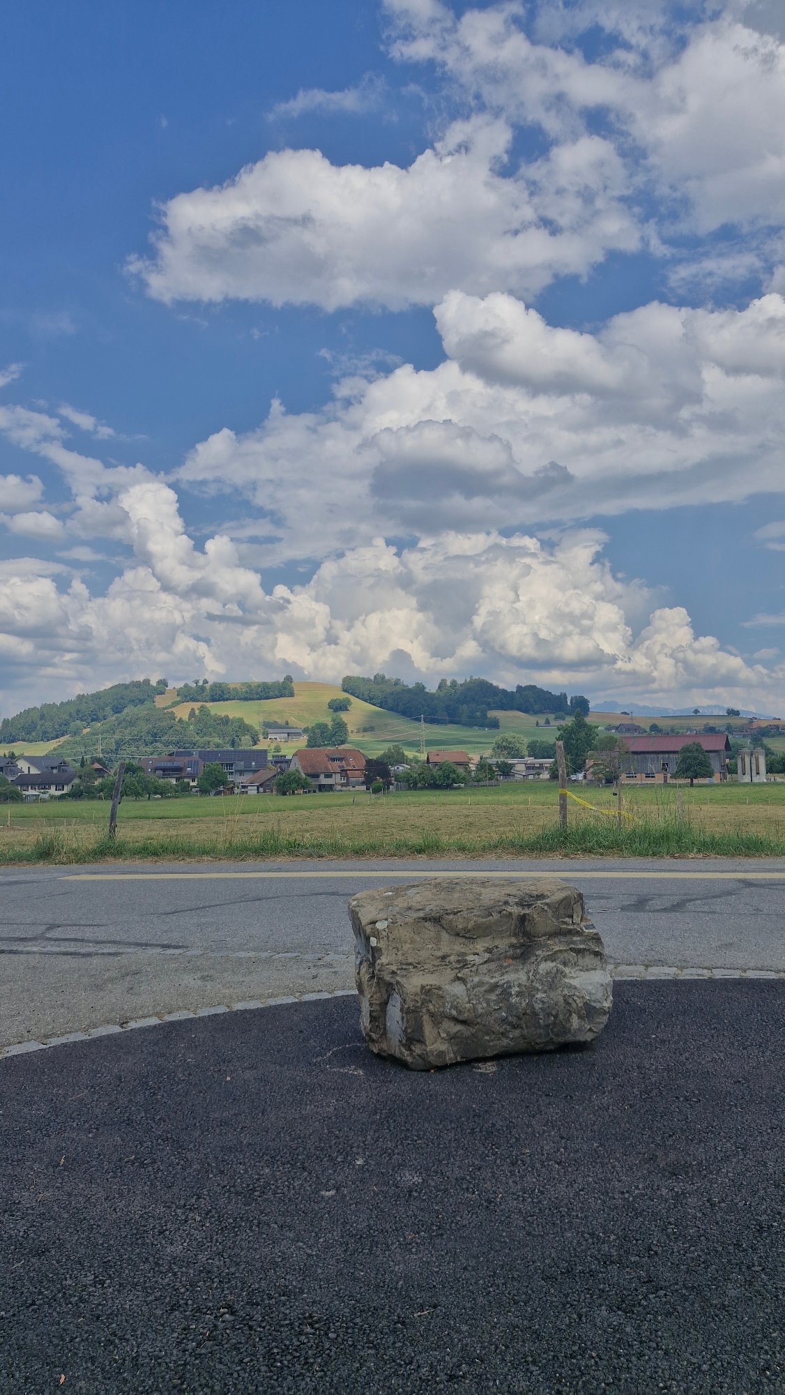 Boulders by the roadside under a cloudy rural sky