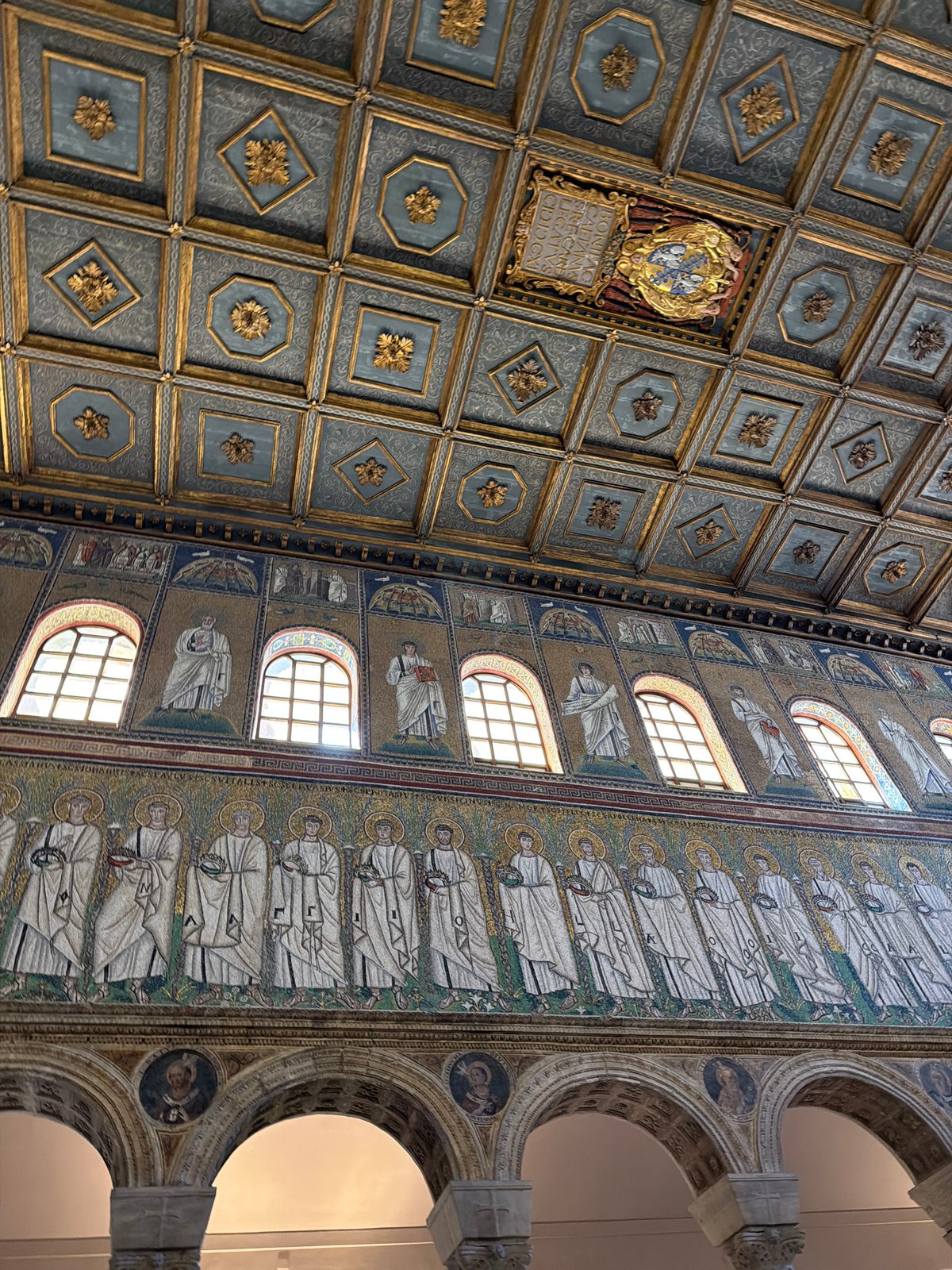 Visitor documents historic Basilica di Sant'Apollinare Nuovo interiors in Ravenna