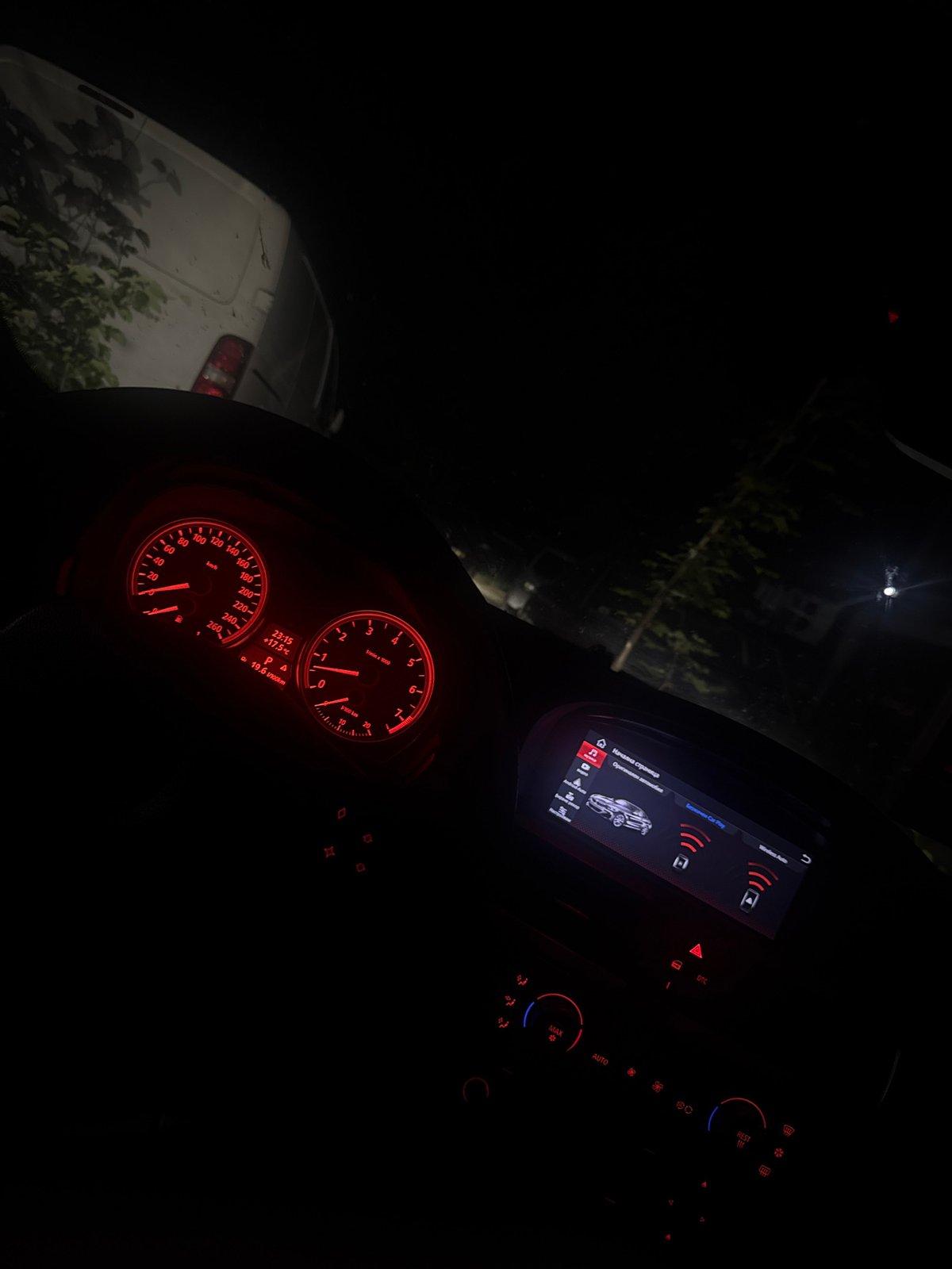 Driver documents illuminated car dashboard during nighttime journey in Bulgaria