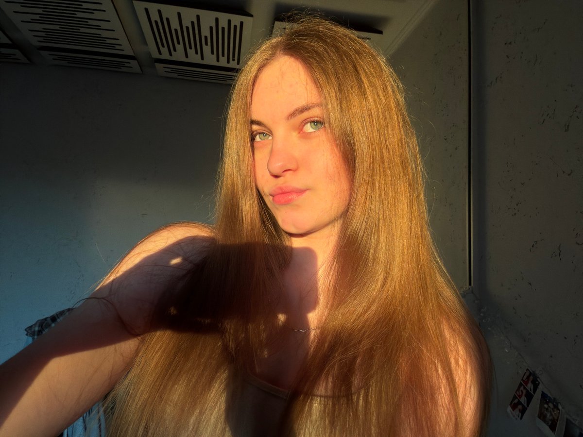 Golden hour selfie session in Dnipro, with city sunset backdrop.