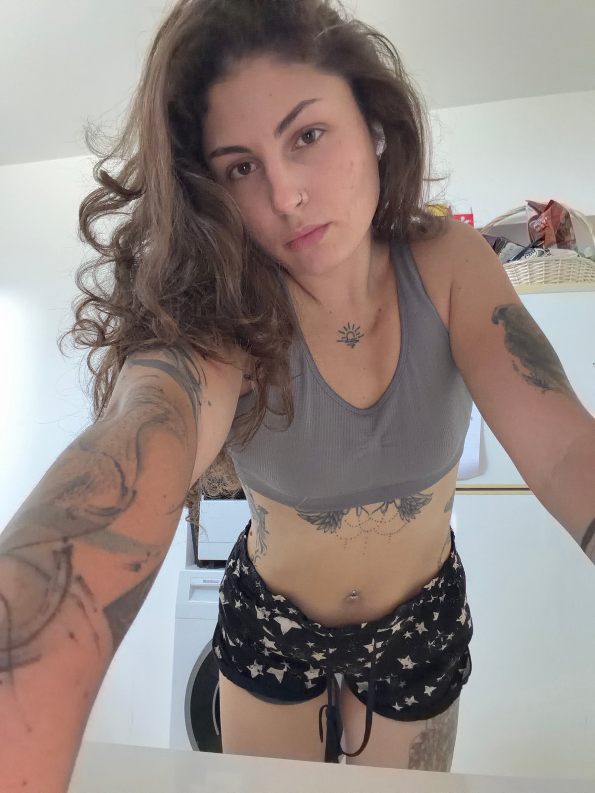 Woman records fitness video in kitchen, Kiryat Bialik