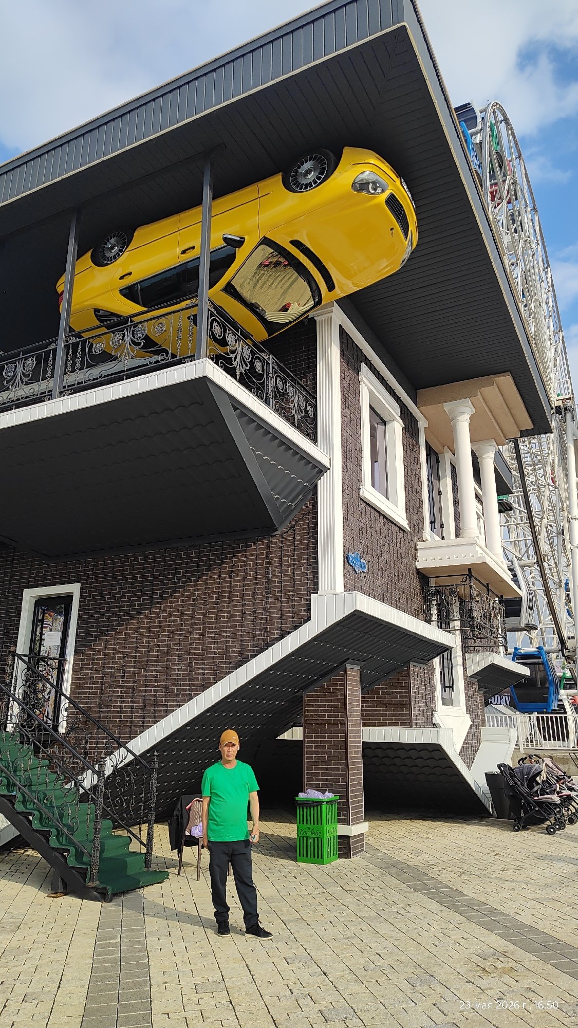Tourist visits upside-down house attraction in Almaty, Kazakhstan