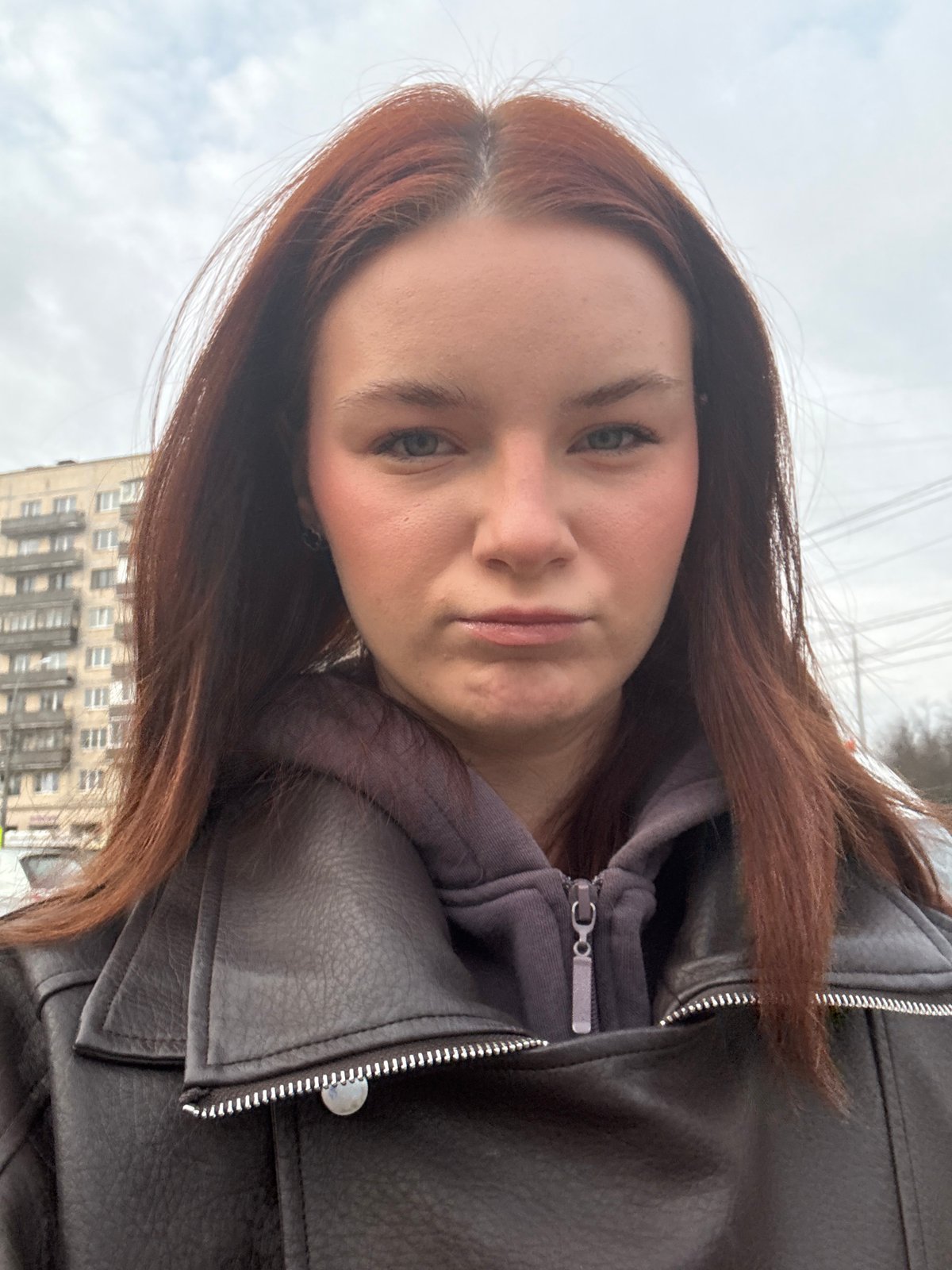 Woman takes selfie outside building in Russian city