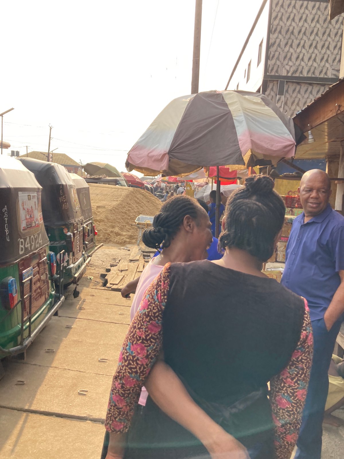 Auto rickshaws line busy Aba market scene