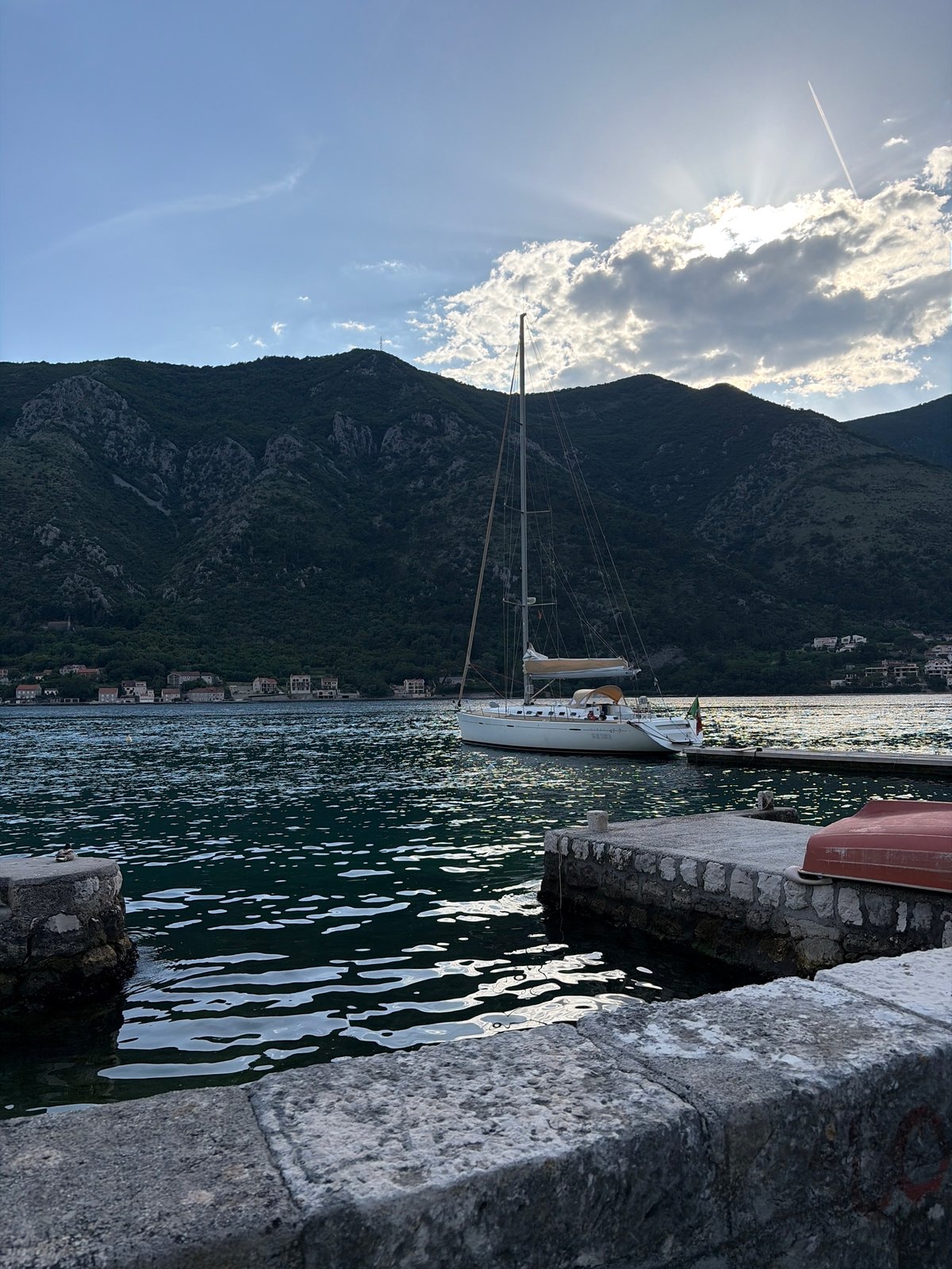Boats dock at stone pier in Dobrota, Montenegro
