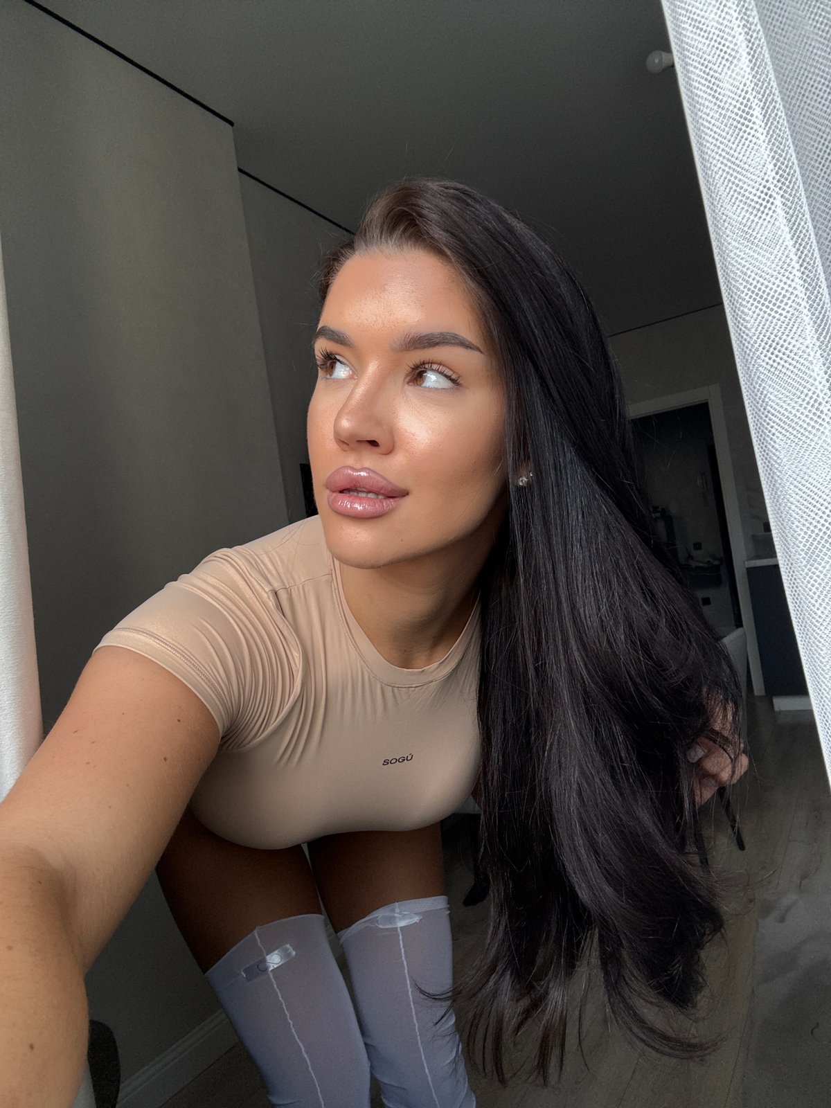 Woman in beige outfit observed indoors in Kazan