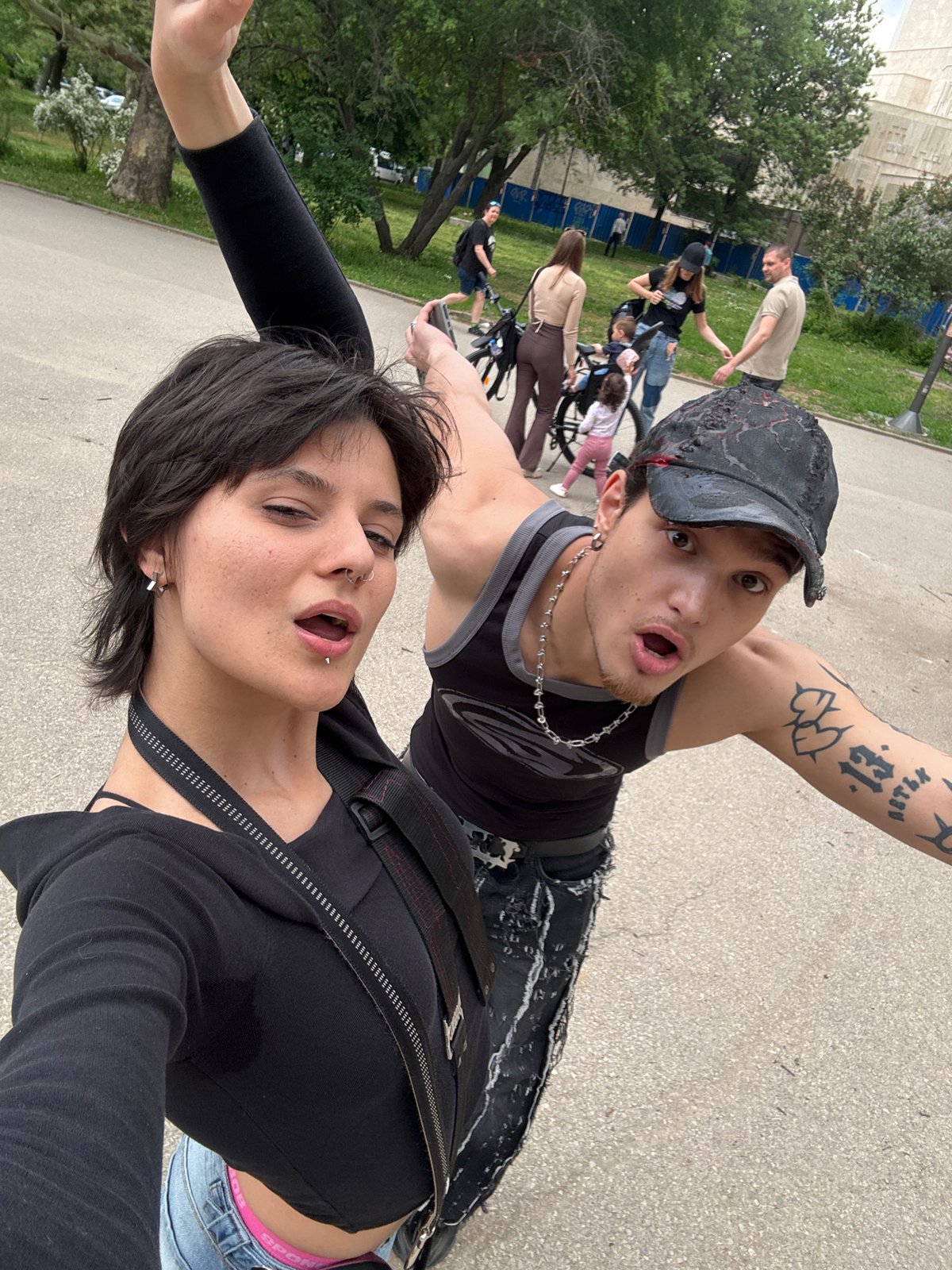Young couple takes selfies, dogs play in Sofia park