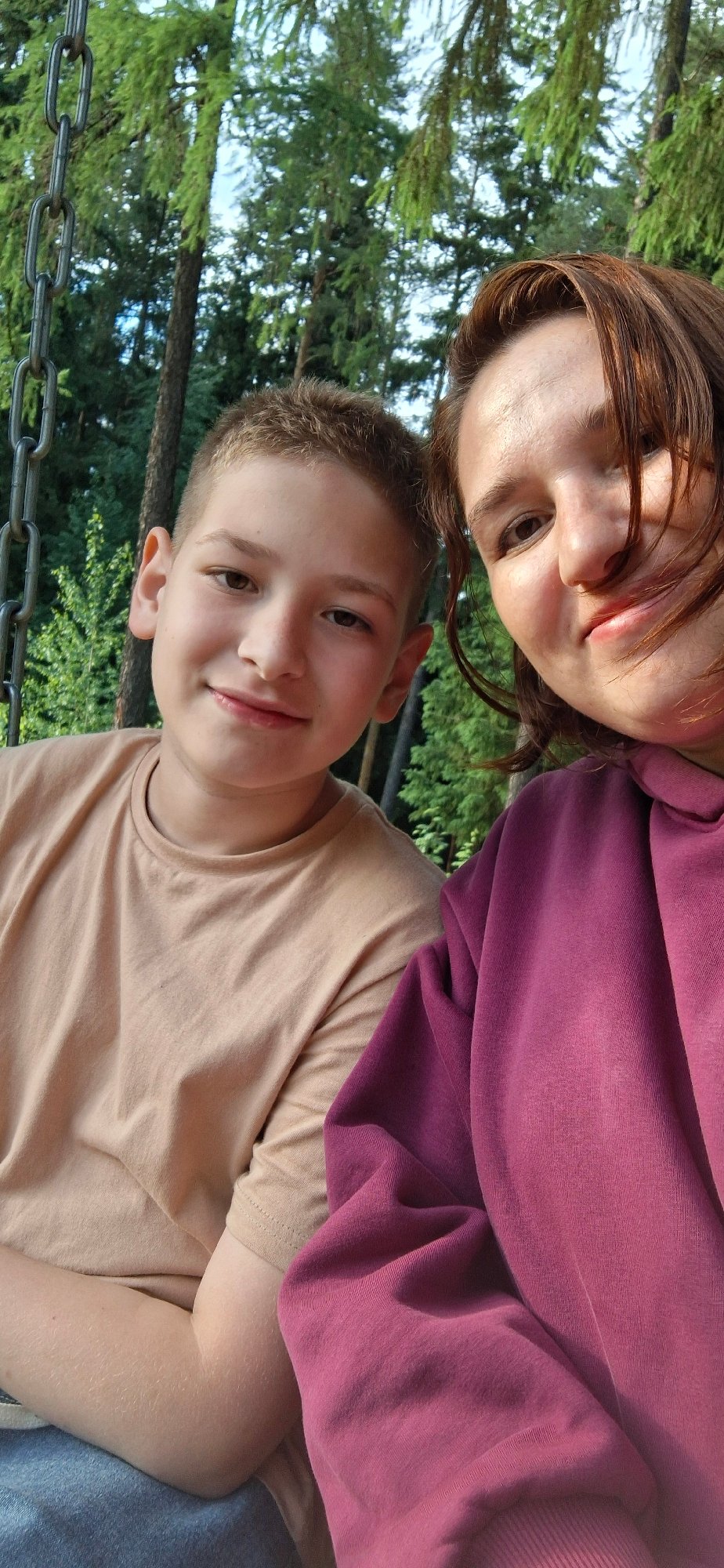 Family enjoys afternoon outing at wooded park in Прикамский