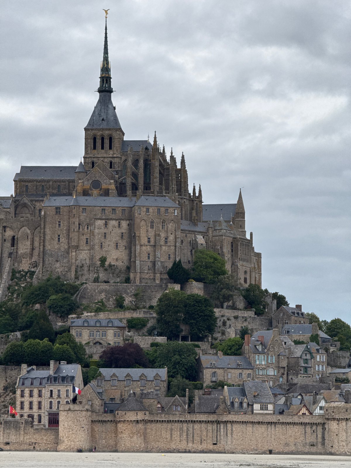 Mont-Saint-Michel abbey photographed under cloudy skies in France