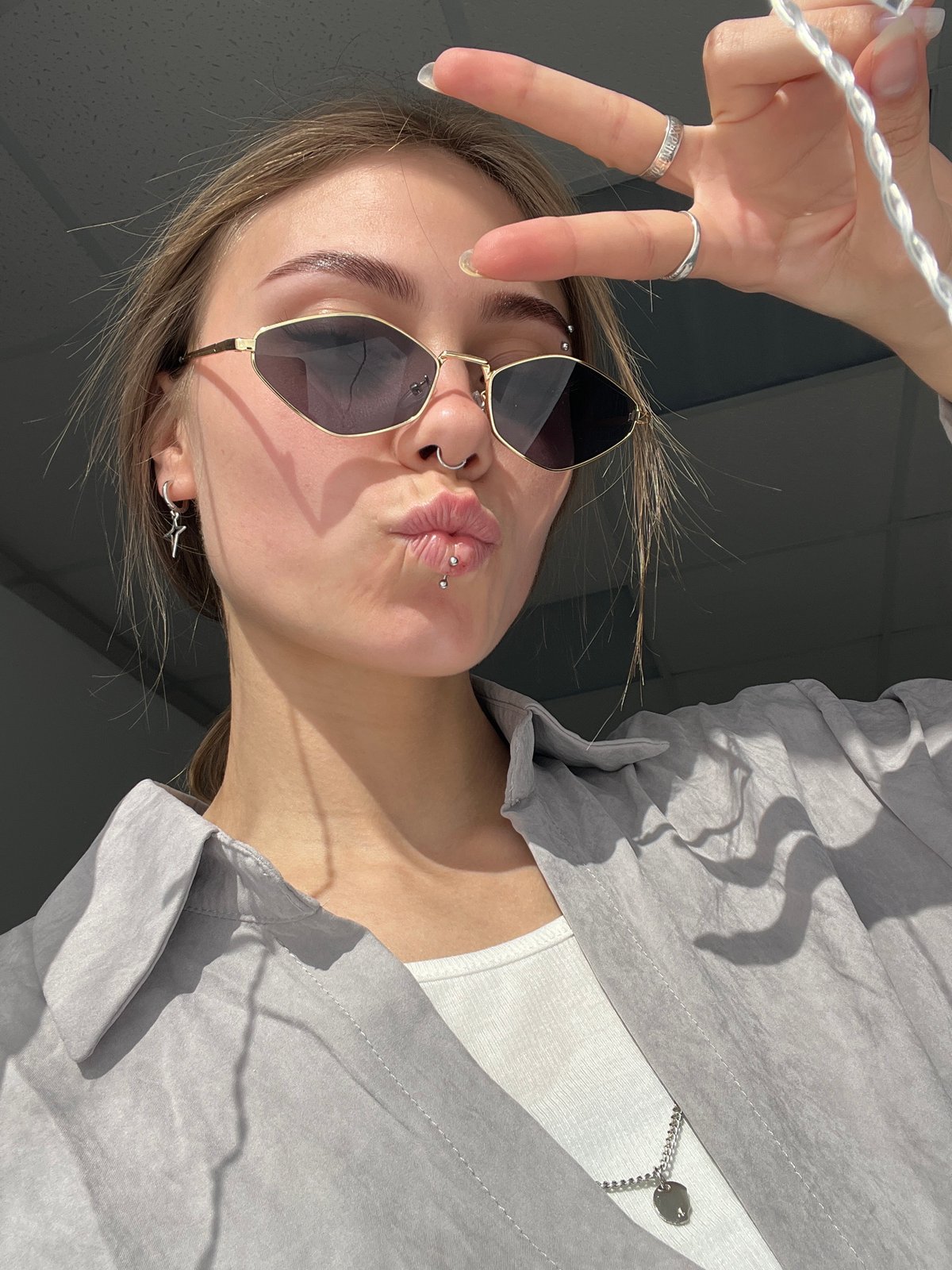 Young women photograph themselves during morning selfie session
