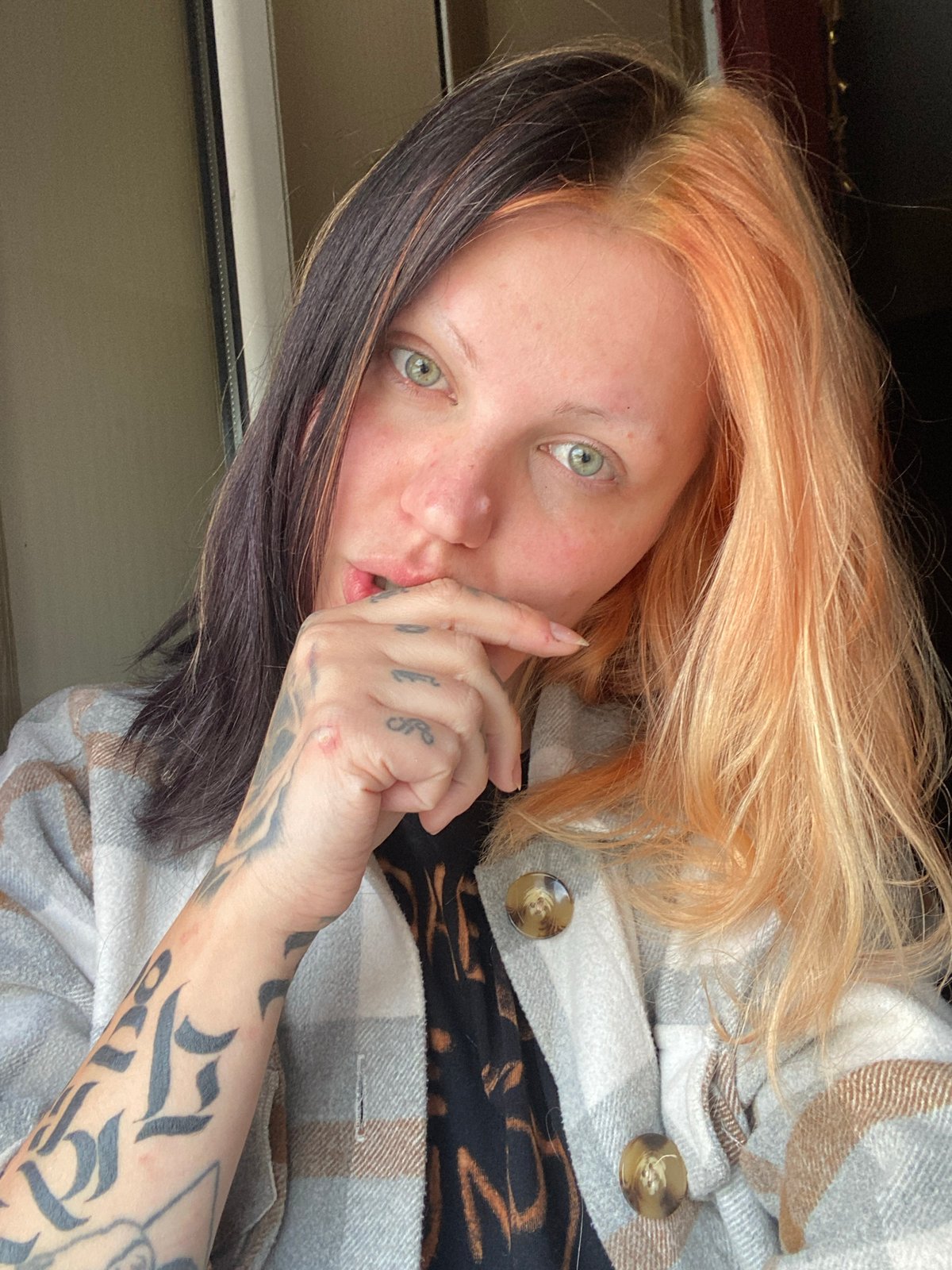 Woman with distinctive hair smokes cigarette in Montenegro village