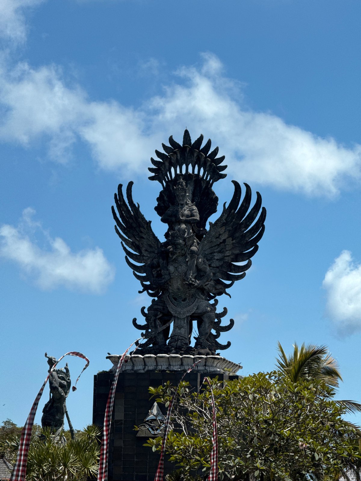 Garuda statue photographed against blue sky in Kuta Selatan