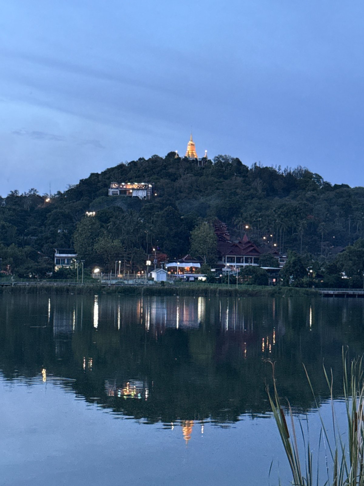 Hilltop stupa and lit-up bar at dusk, Baan Chaweng