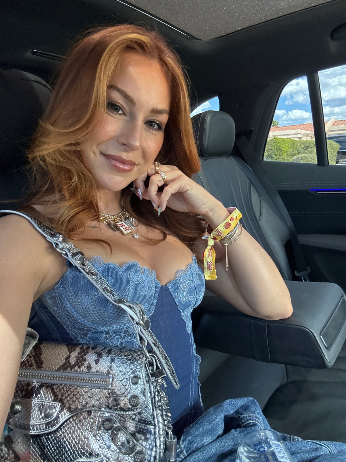 Woman photographed smiling in vehicle backseat in Bermuda Dunes