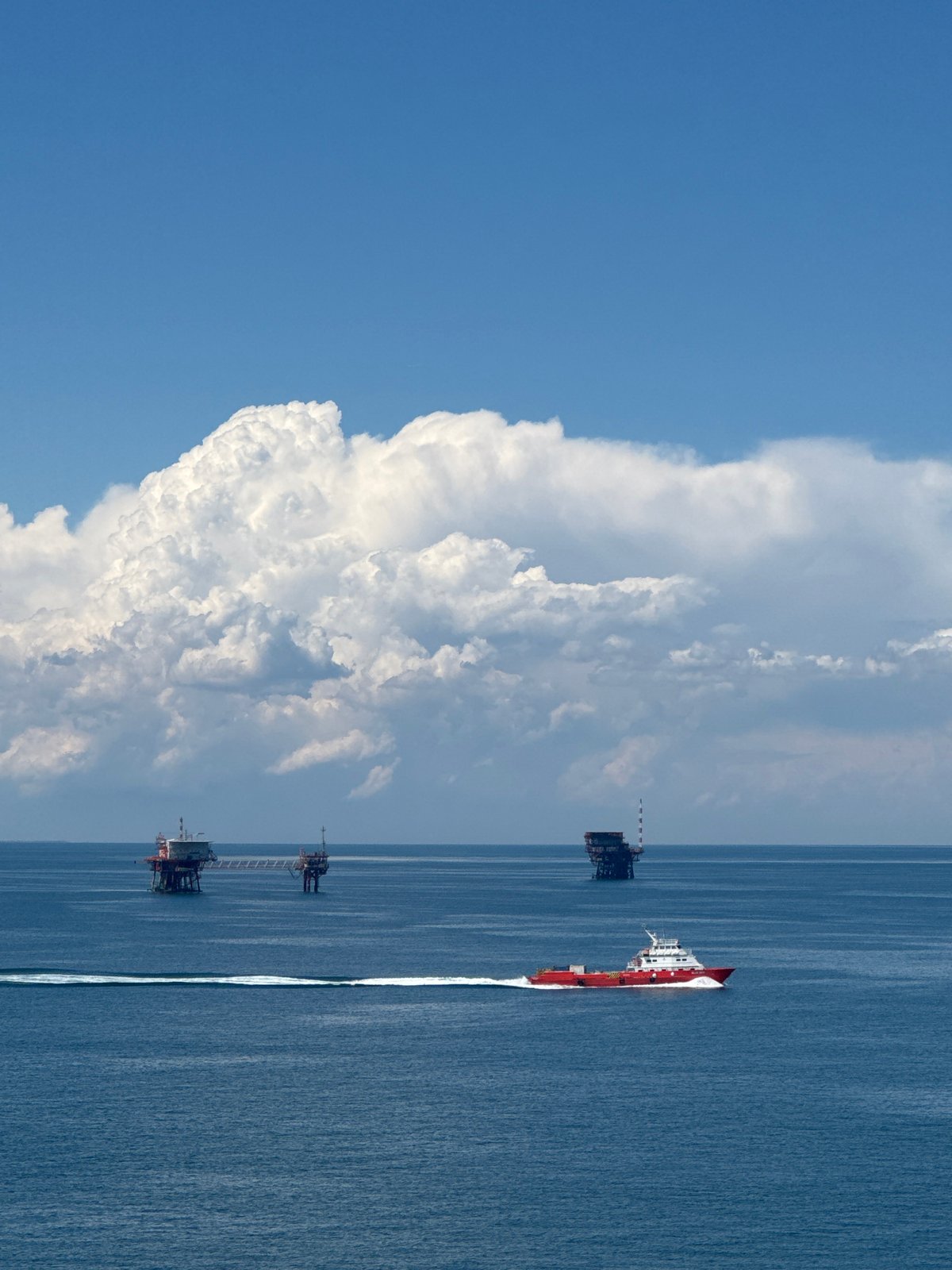 Supply vessel transits Italian offshore oil platforms during afternoon