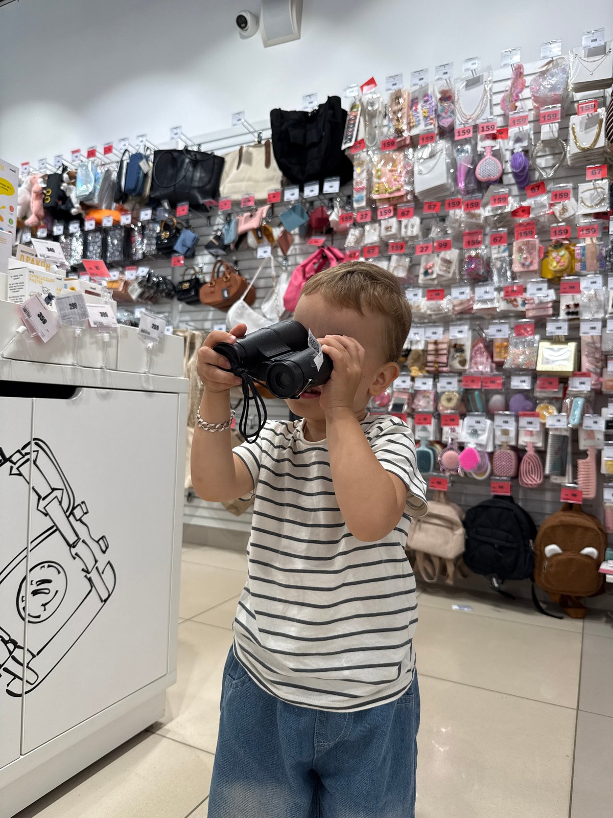 Kids trying out toys and gadgets in a Zhukovo store