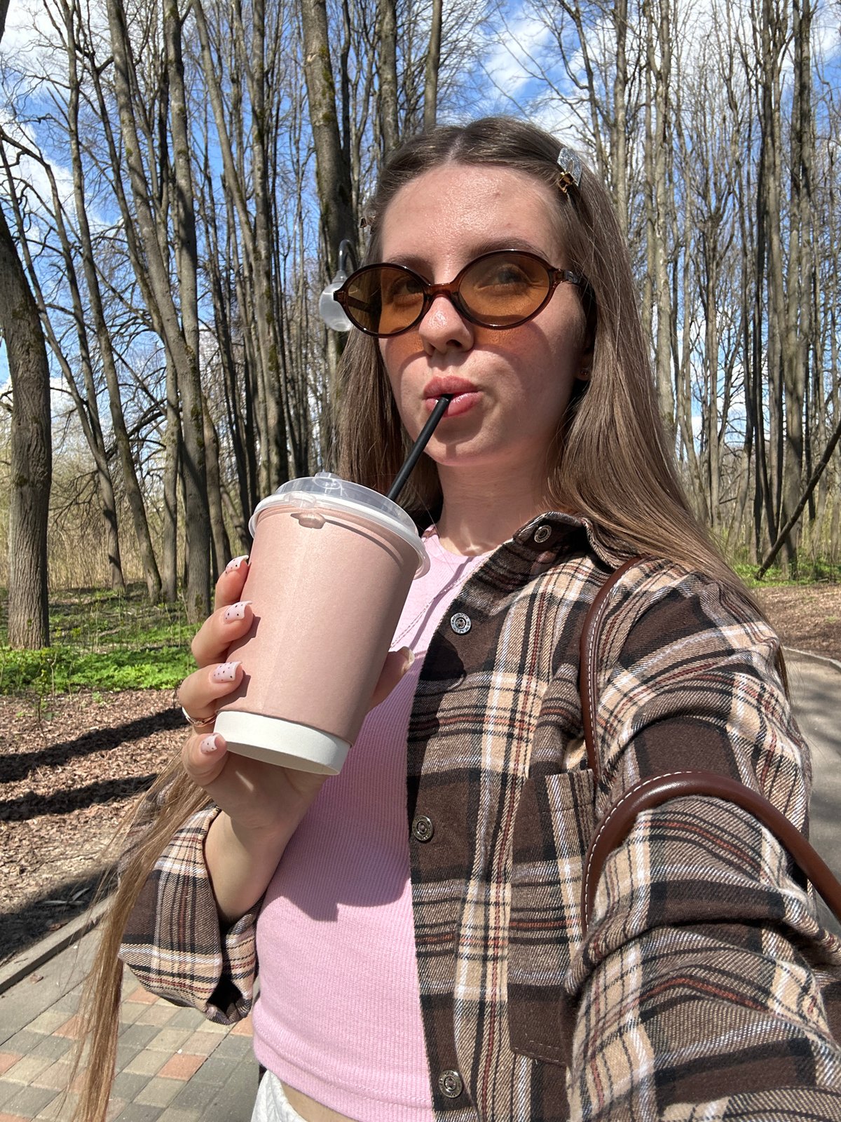 Woman with drink spotted outdoors in sunny Klin, Russia