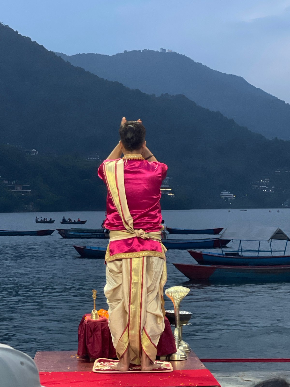 Religious ceremony held on waterfront platform in Pokhara, Nepal
