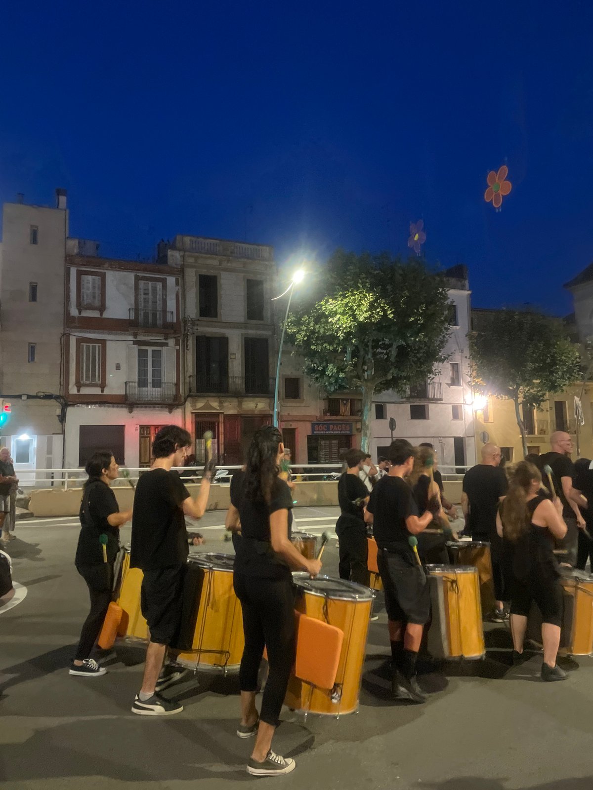 Drum parade rolls through Arenys de Mar streets at dusk