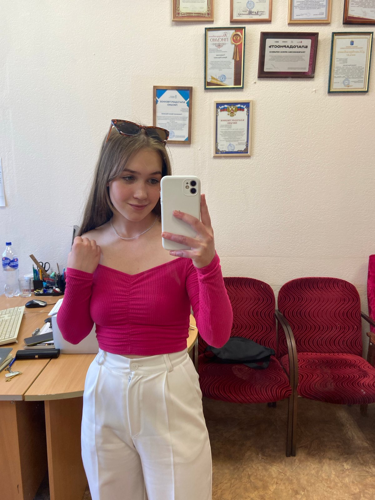Young woman takes selfie in Chaikovsky office setting