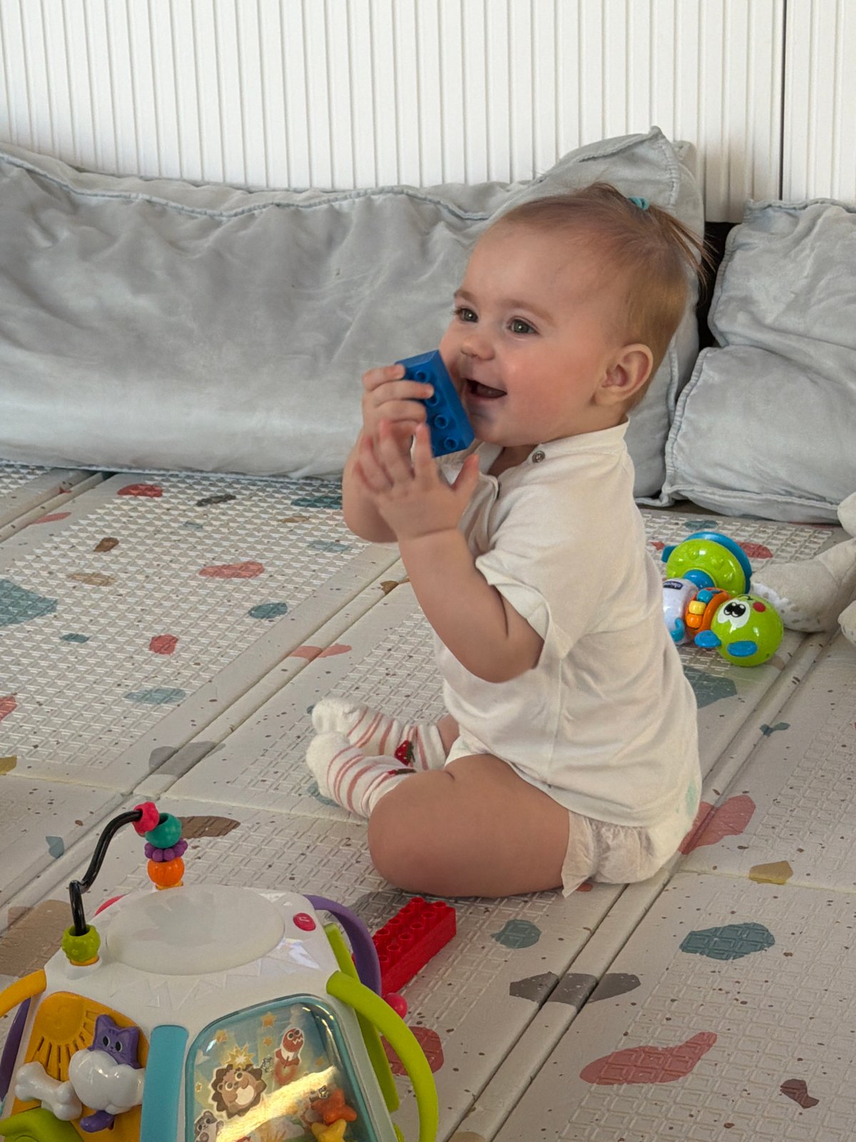 Baby plays with blocks on mat in Krasnoyarsk