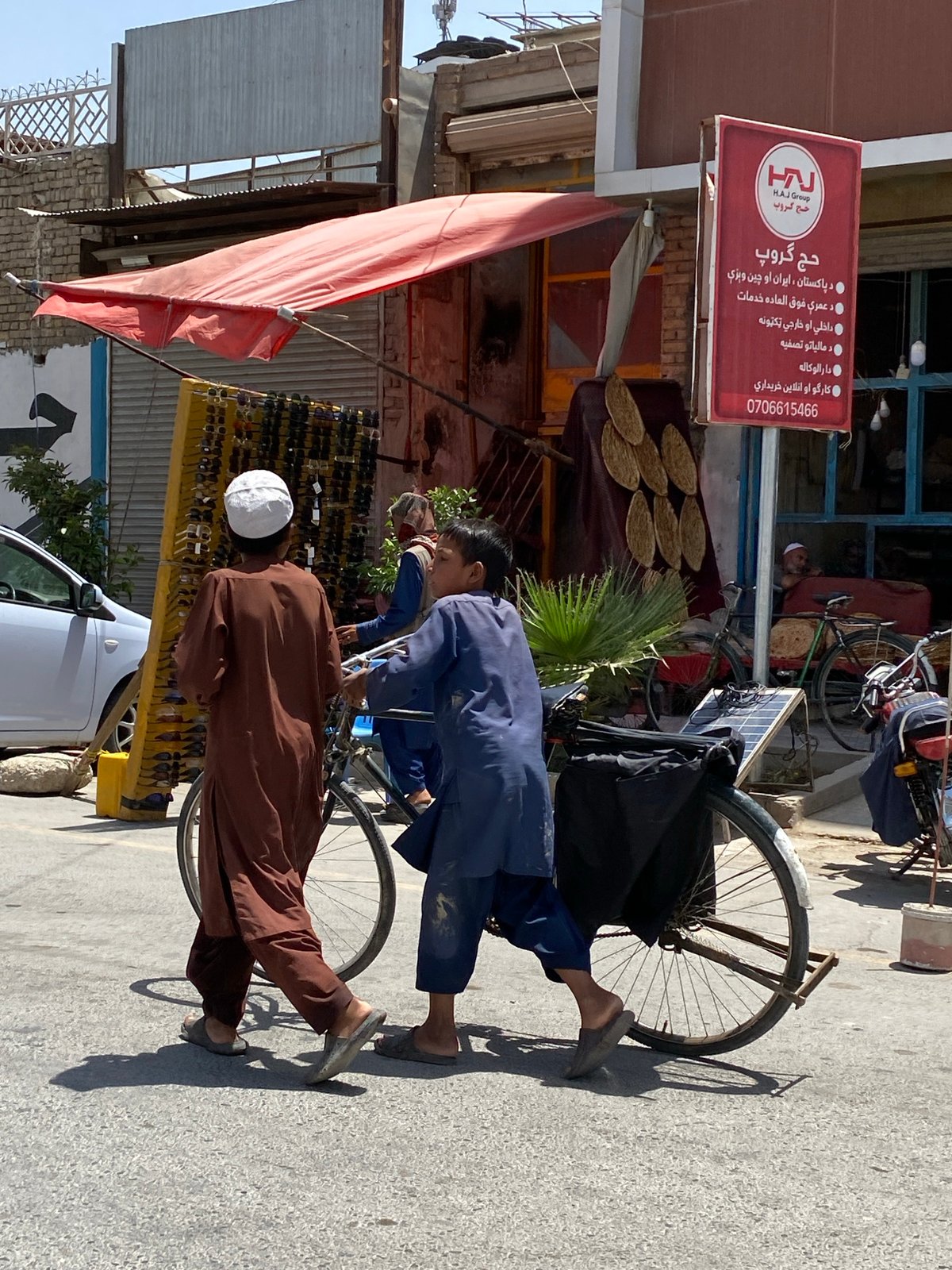 Everyday street life in Kandahar, vendors and pedestrians mid-morning