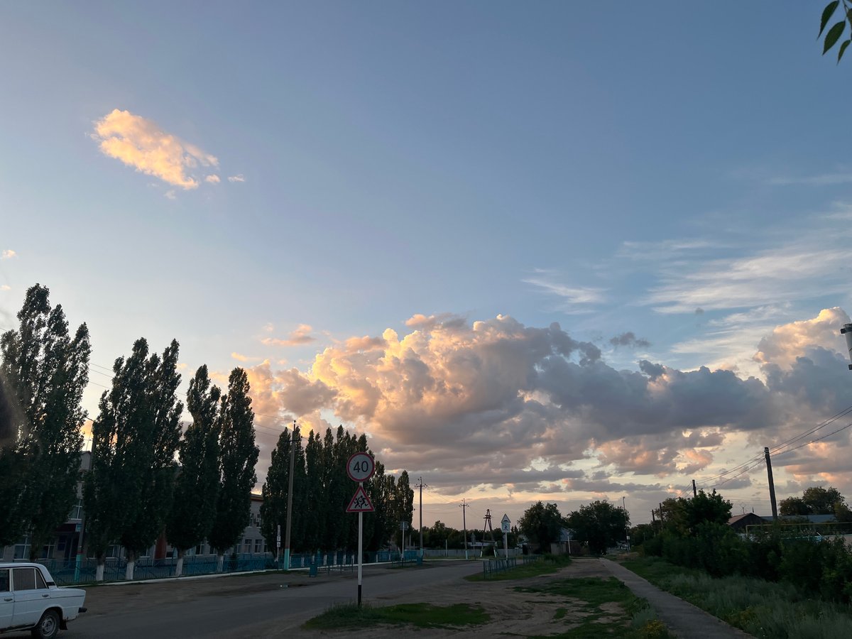 Golden hour light over Qobda streets and open sky