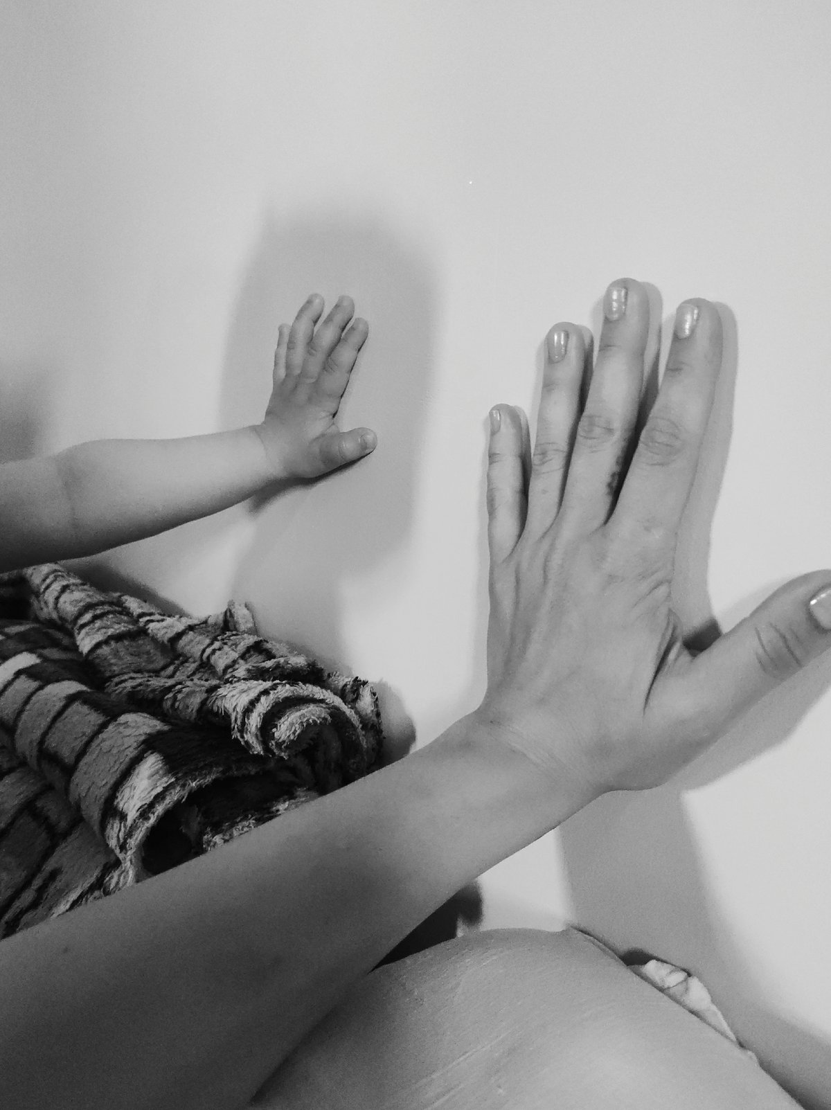 Adult and child share quiet moments in black and white