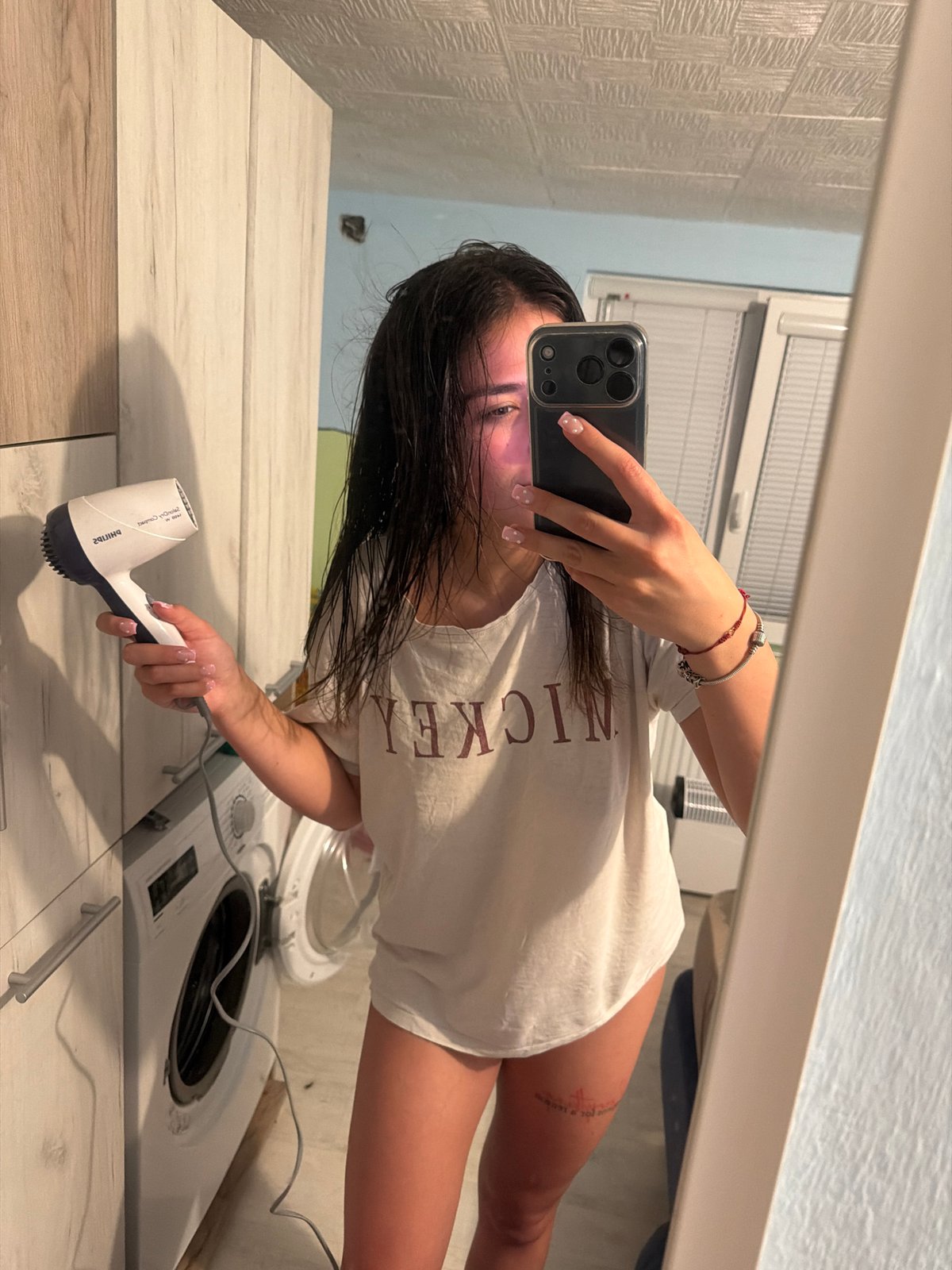 Woman documents hair-drying routine in Bulgarian bathroom selfies
