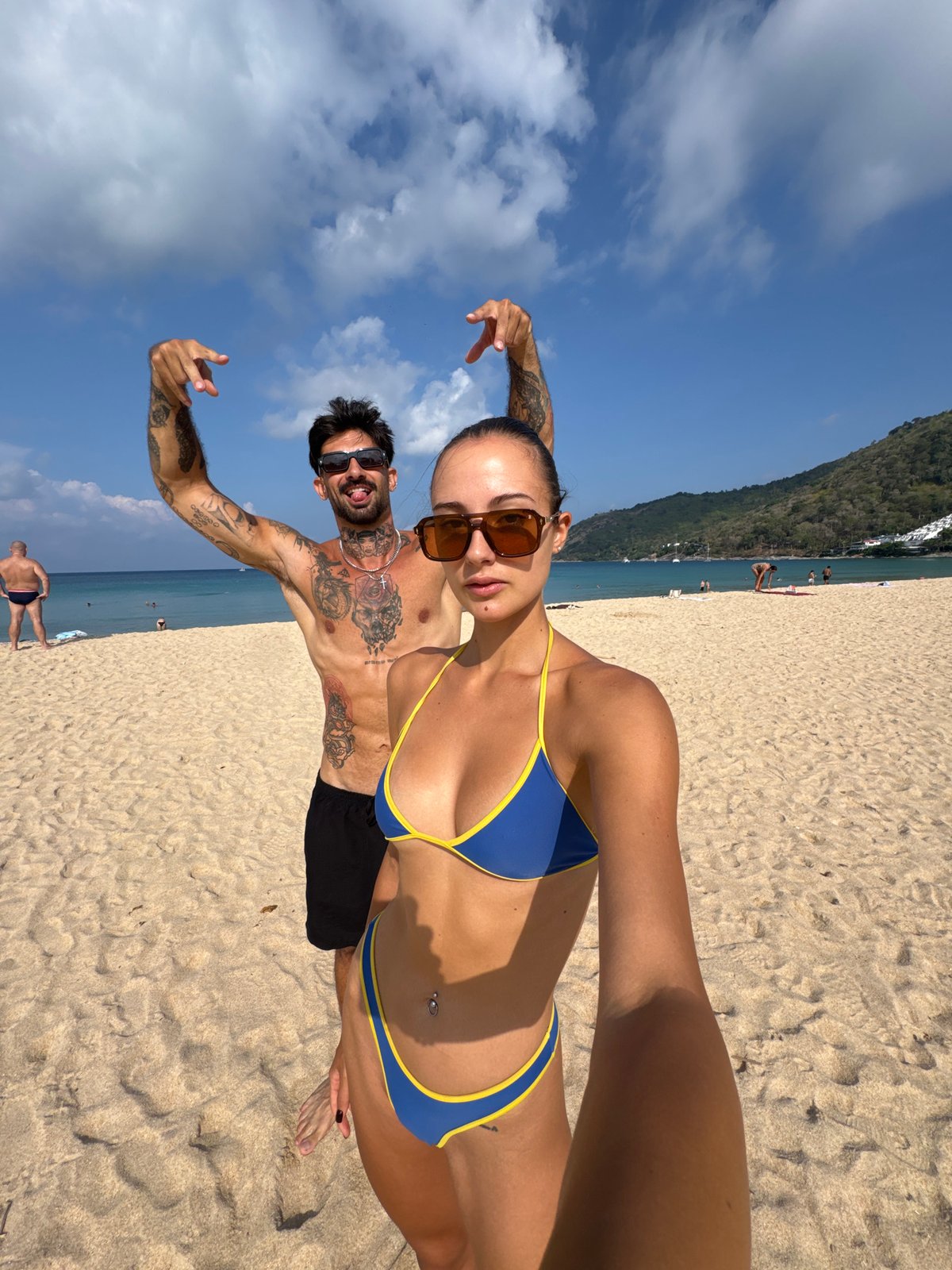 Couple takes beach selfies at Rawai Thailand early morning