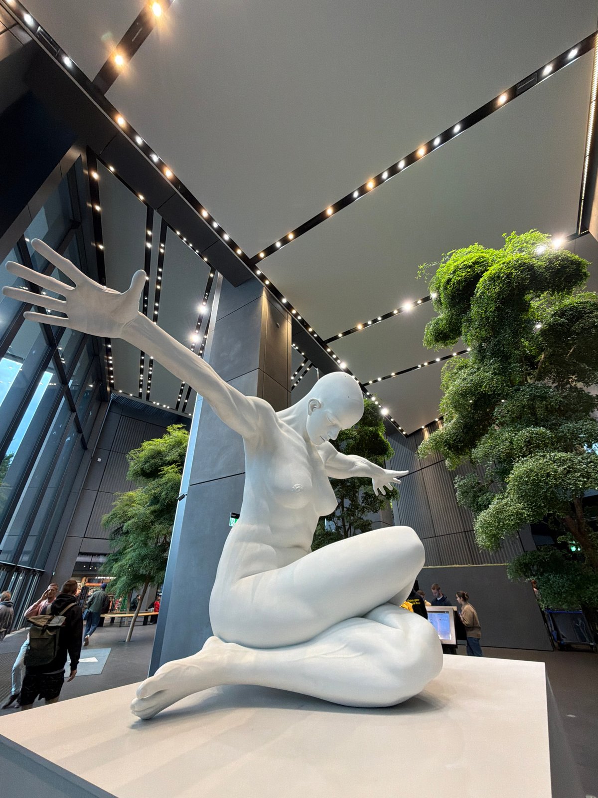 Abstract white sculpture anchors a Warsaw atrium lobby