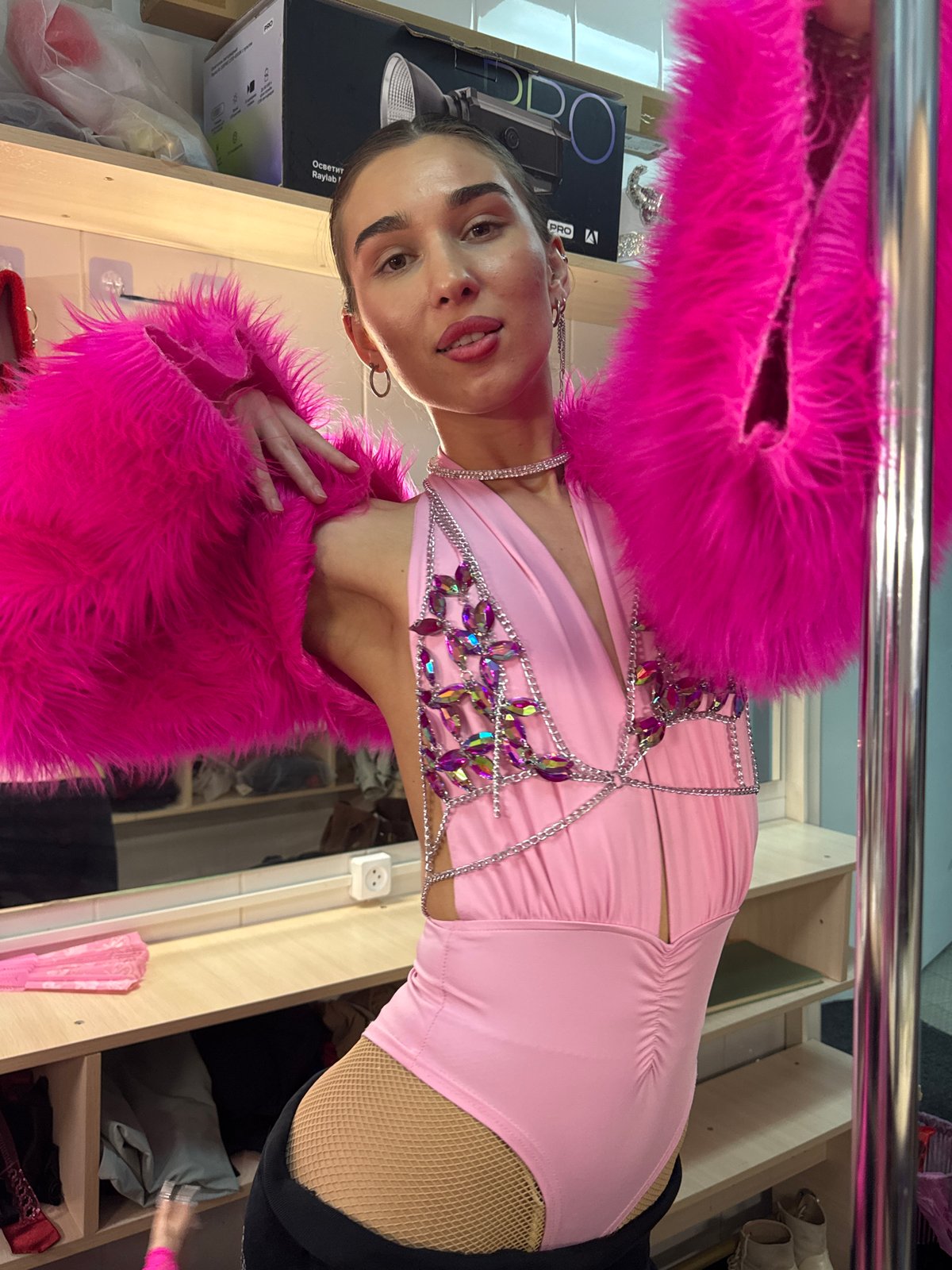 Women pose for photos in pink outfits in Kazan dressing room