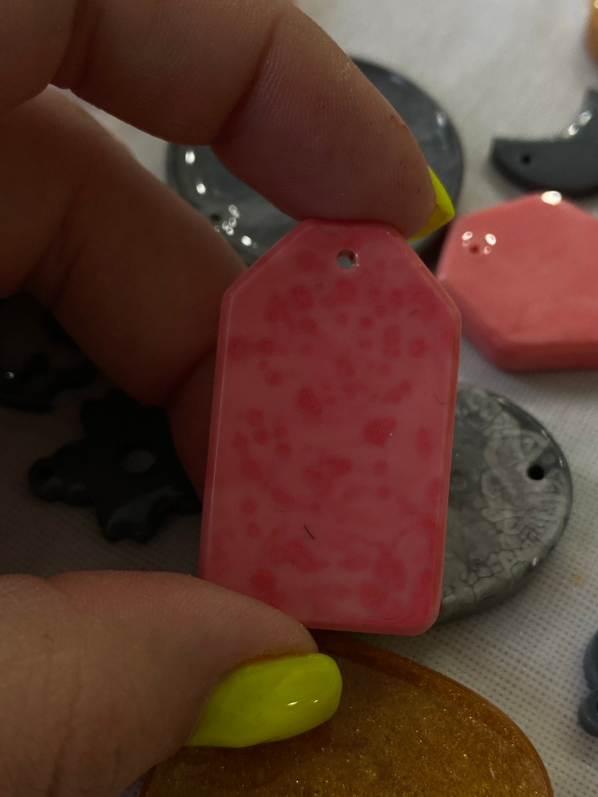 Handmade resin pendants and decorative clocks at a Balashikha craft session