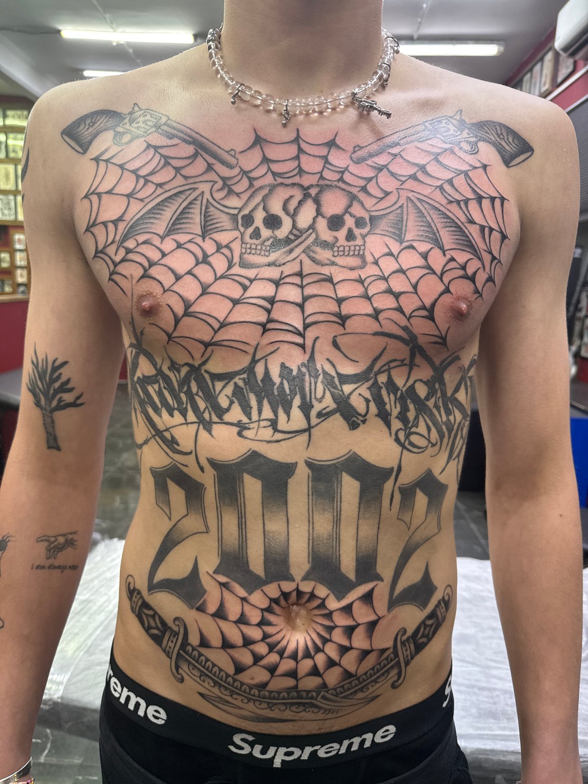 Heavily tattooed individual documented in Moscow wearing designer underwear