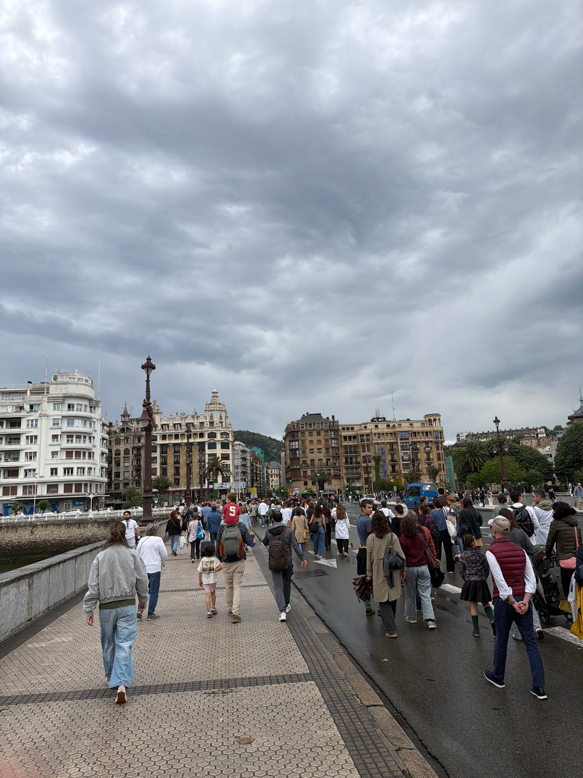 Bustling waterfront promenade scene observed in San Sebastián
