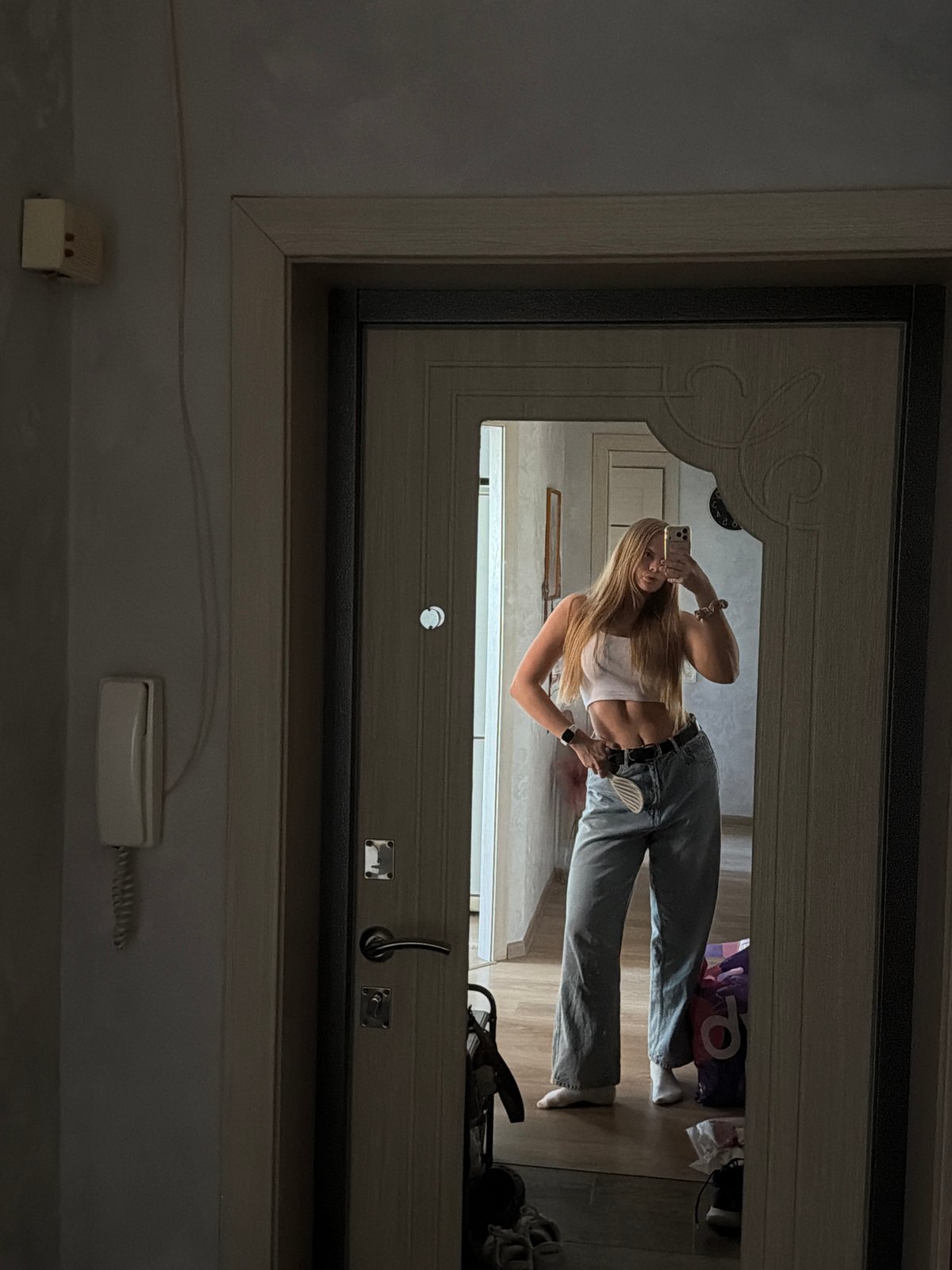 Woman takes mirror selfies during morning routine in Chaikovsky