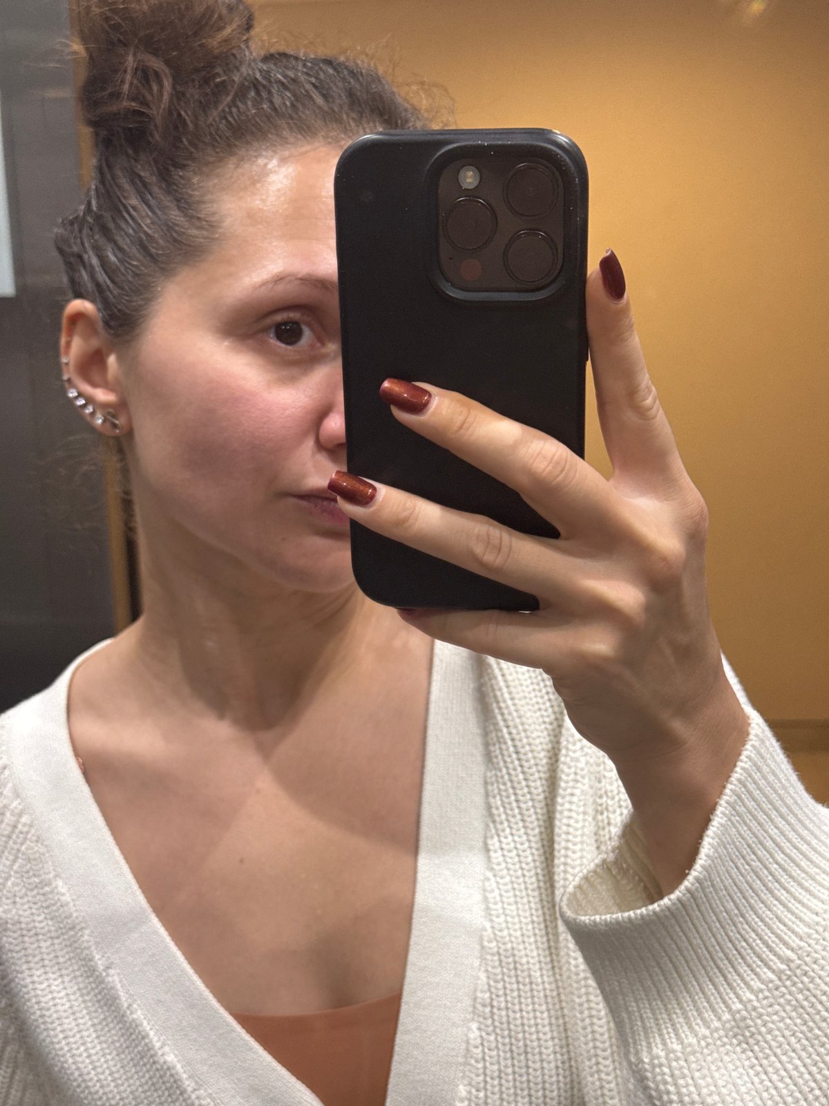 Woman takes selfie in white sweater in Dubai