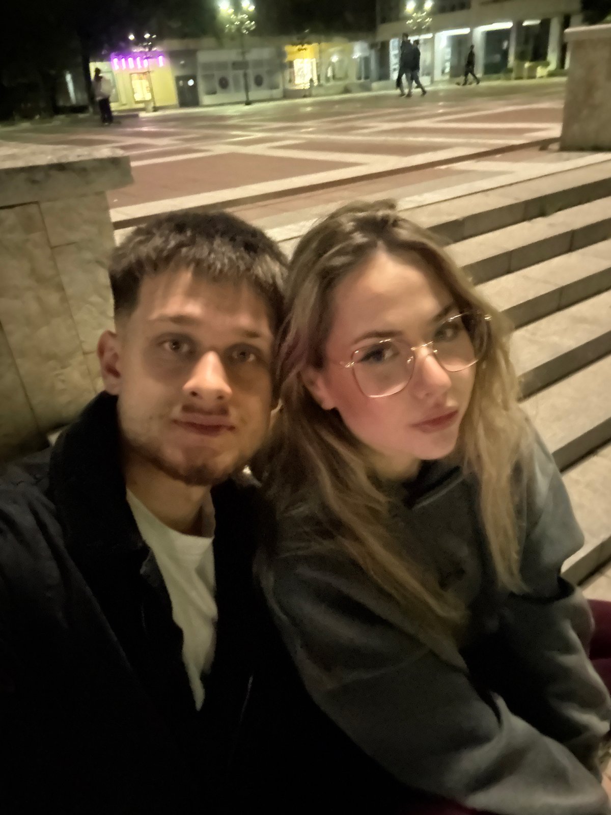 Couple takes evening selfies at illuminated Blagoevgrad fountain