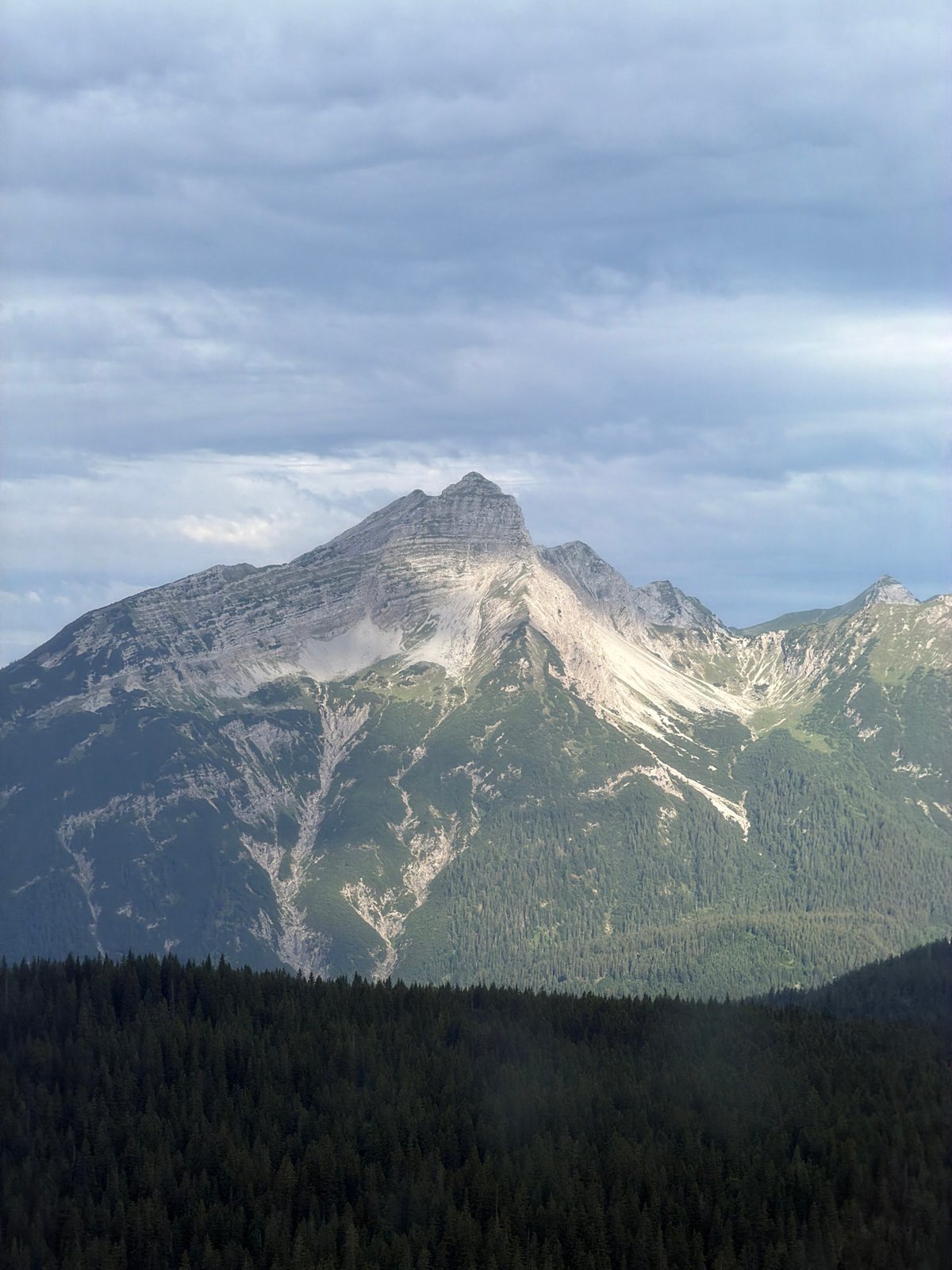 Cable car infrastructure and rocky peaks near Grainau on an overcast morning