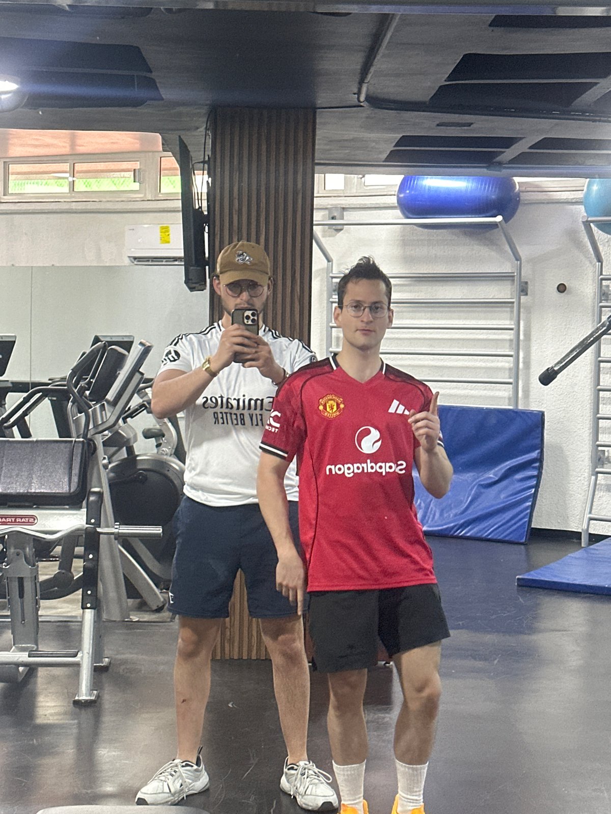 Two men take gym selfie in soccer jerseys