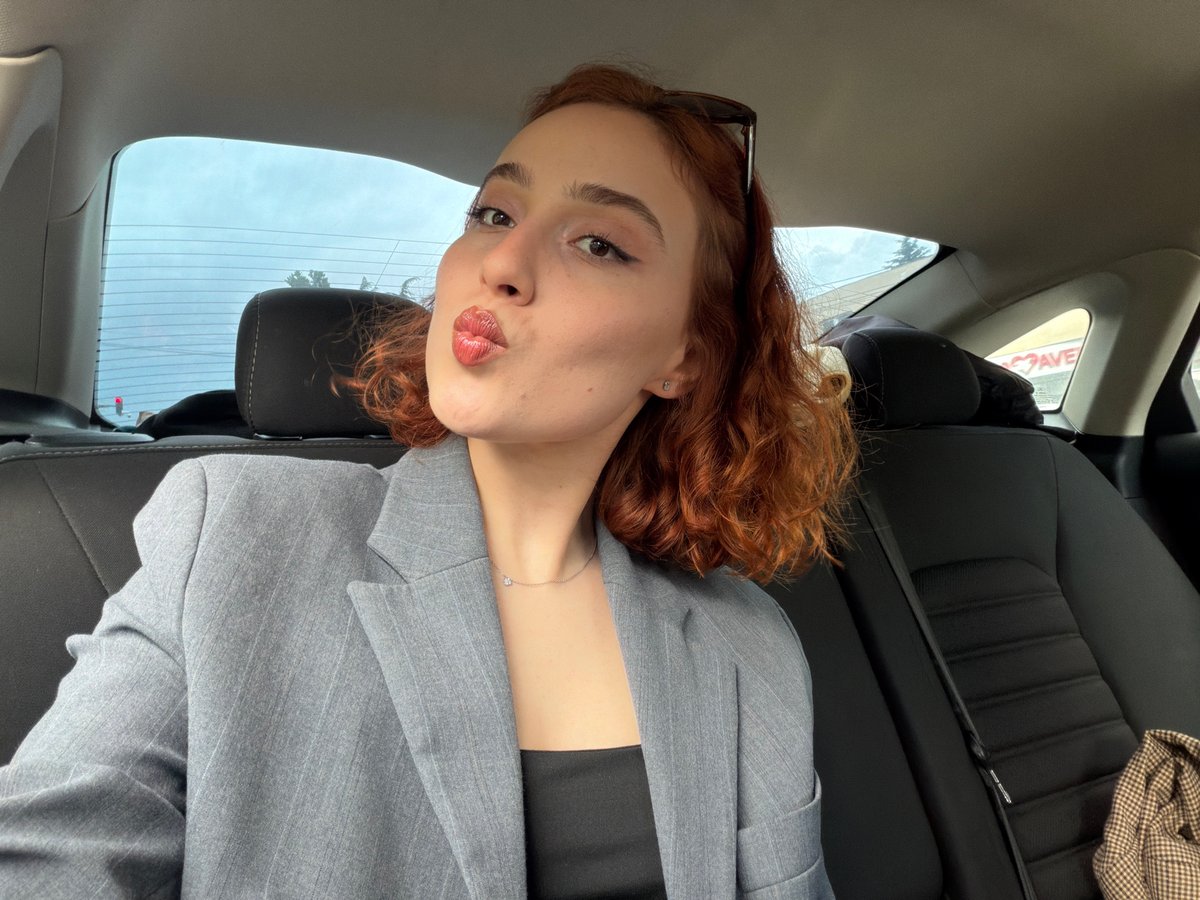 Woman in gray blazer photographed in car, Tbilisi
